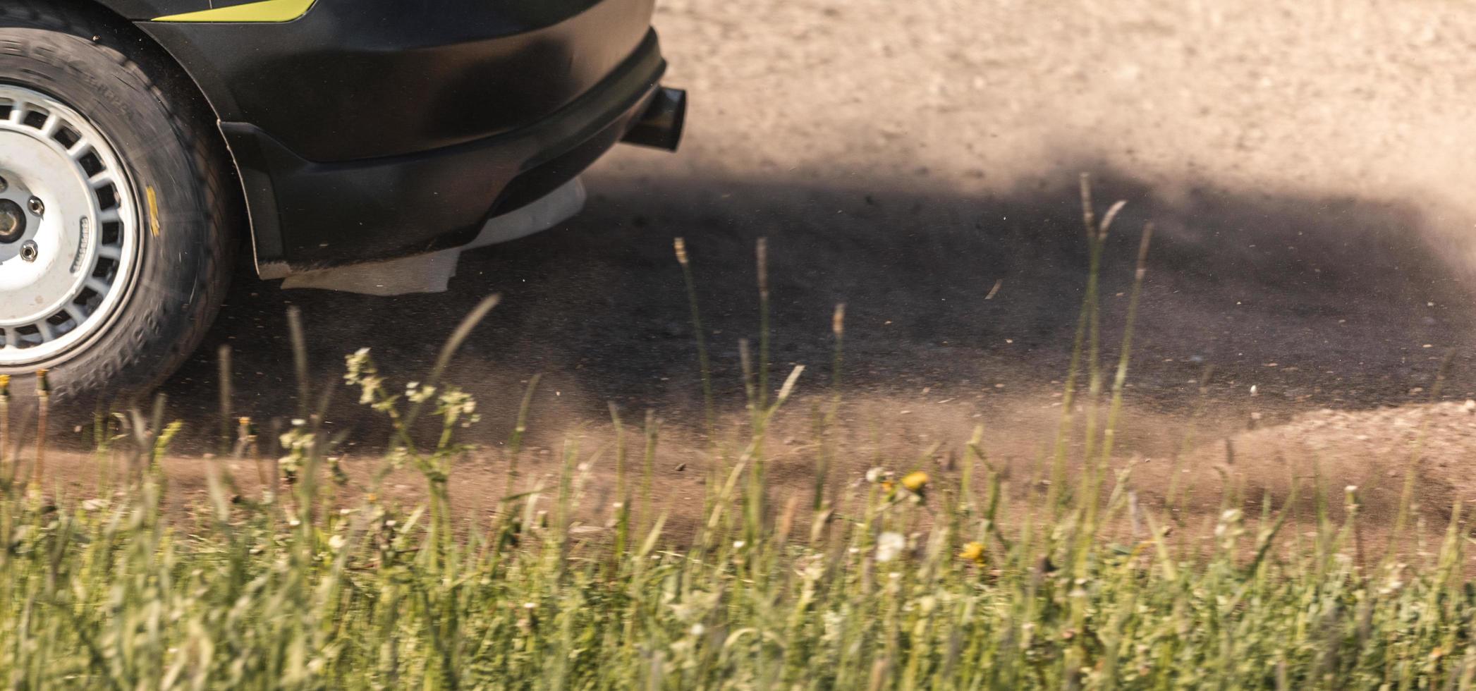 Gravel flying behind a rally car photo