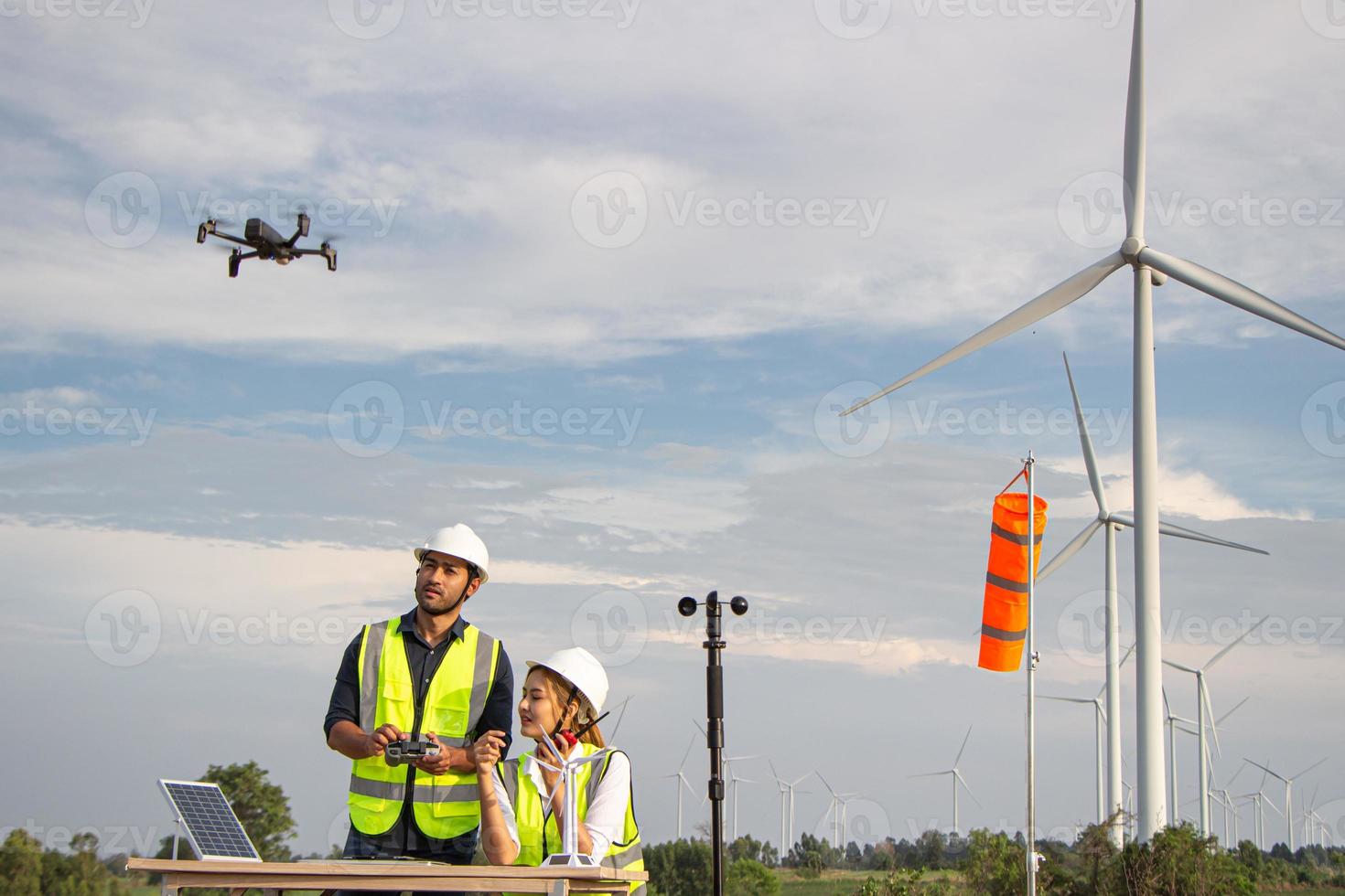 engineer team working in wind turbine farm. Renewable energy with wind generator by alternative energy concept. photo