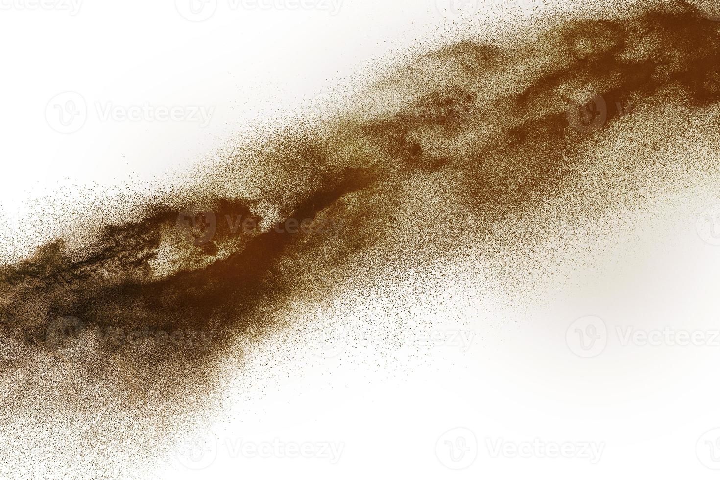 Deep Brown particles splattered on white background. Brown dust splash. photo