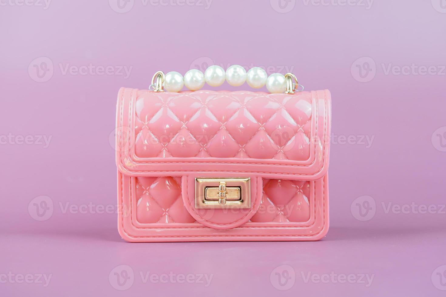 Stylish pink ladies handbag isolated on background. photo