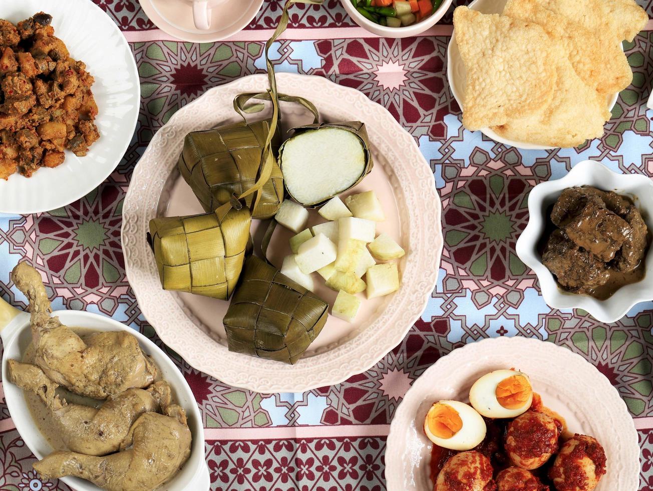 Ketupat Lebaran. Traditional Celebratory Dish of Rice Cake or Ketupat with Various Side Dishes photo