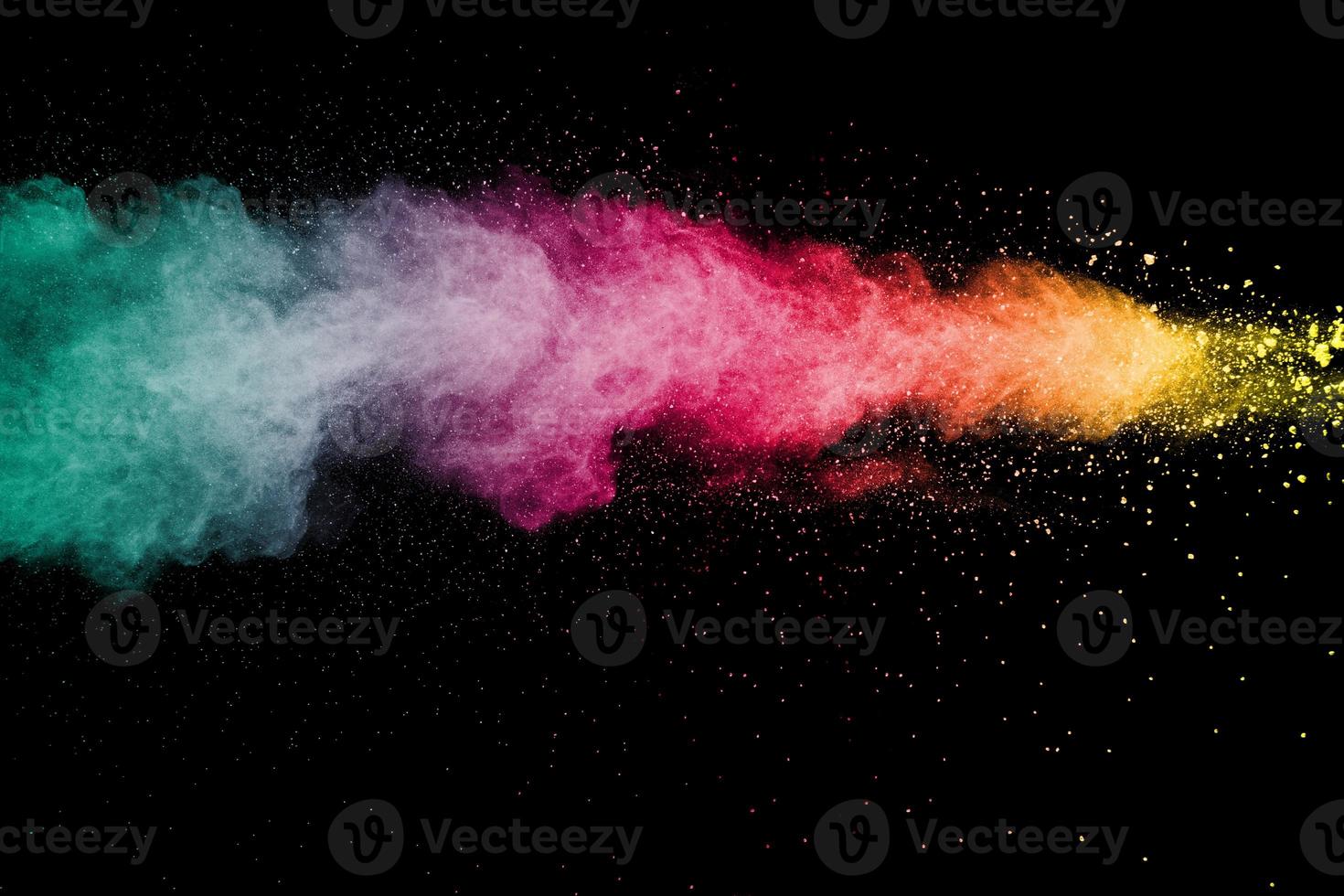 Explosion of color powder on black background. Splash of color powder dust on dark background. photo