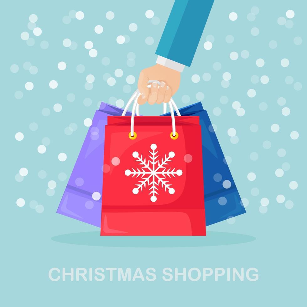 Human hand hold shopping bags with snowflakes. Christmas, new year sale. Vector design