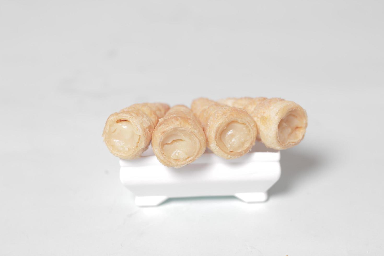 In Indonesia, this cake is known as cumcum cake. A cake shaped like a trumpet, or an ice cream cone. The perfect combination of a dry cake studded with sugar, plus a delicious cream vanilla filling. photo