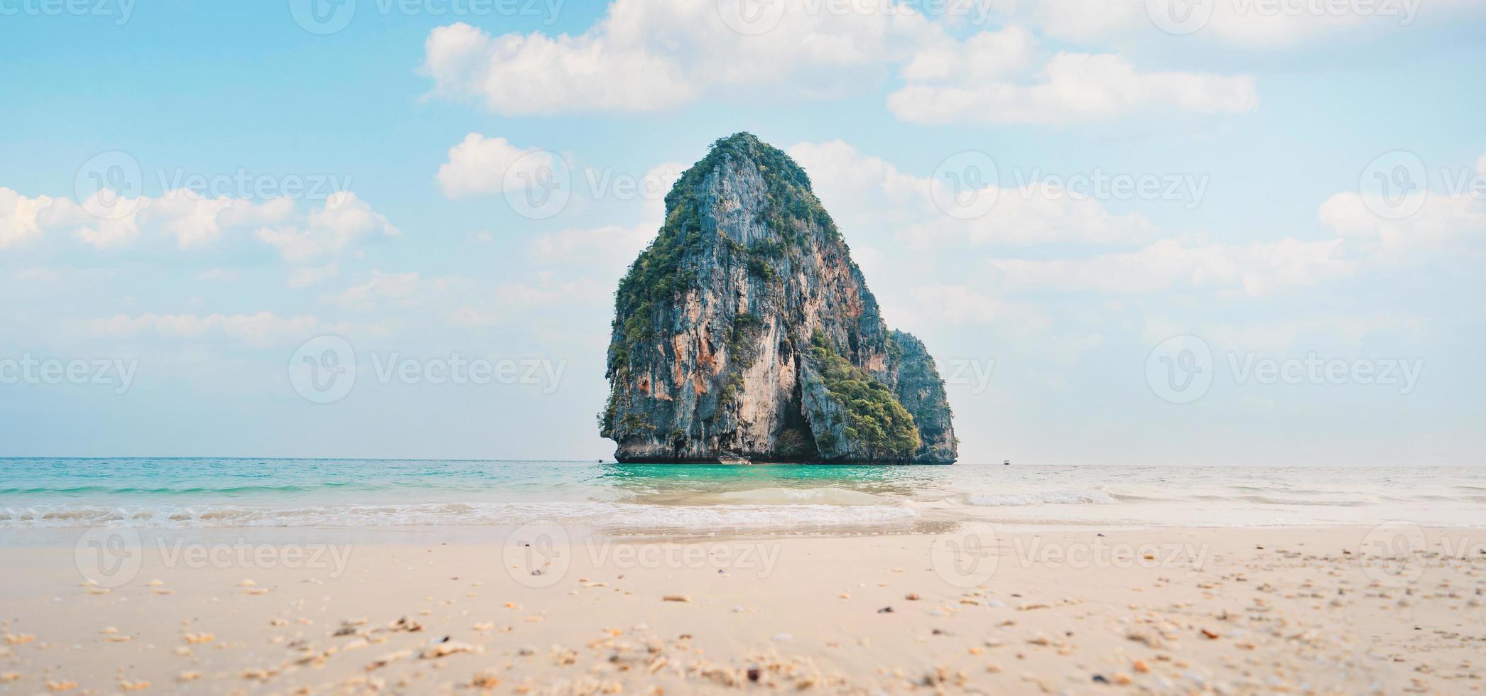 sea, beach and rocky mountains in tropical evening photo