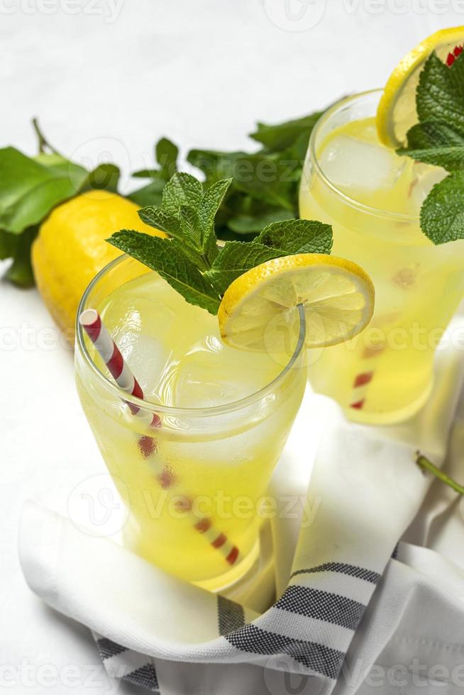 Fresh Lemonade or mojito cocktail with lemon, mint and ice photo
