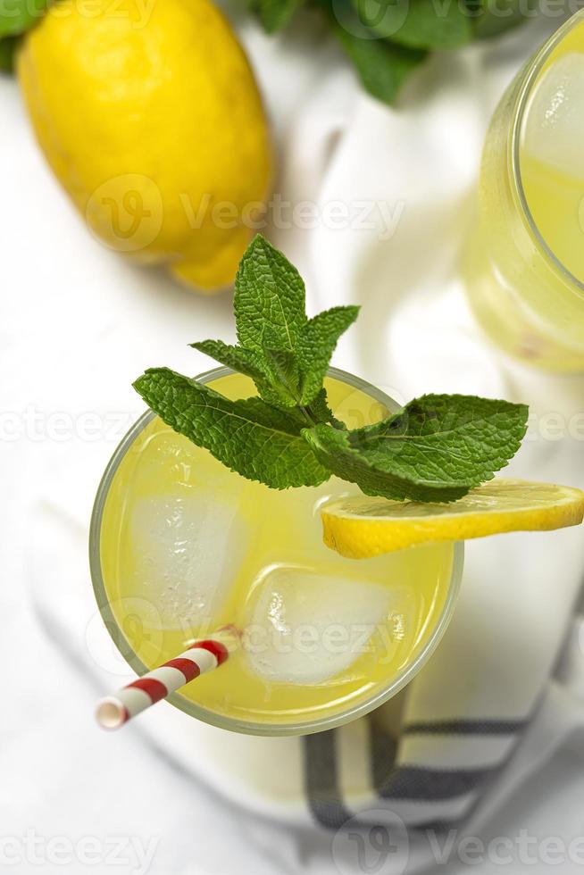 Fresh Lemonade or mojito cocktail with lemon, mint and ice photo