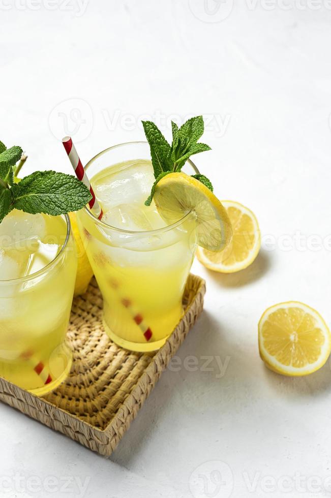 Fresh Lemonade or mojito cocktail with lemon, mint and ice photo