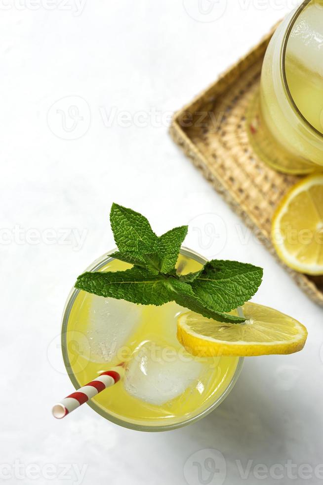 Fresh Lemonade or mojito cocktail with lemon, mint and ice photo