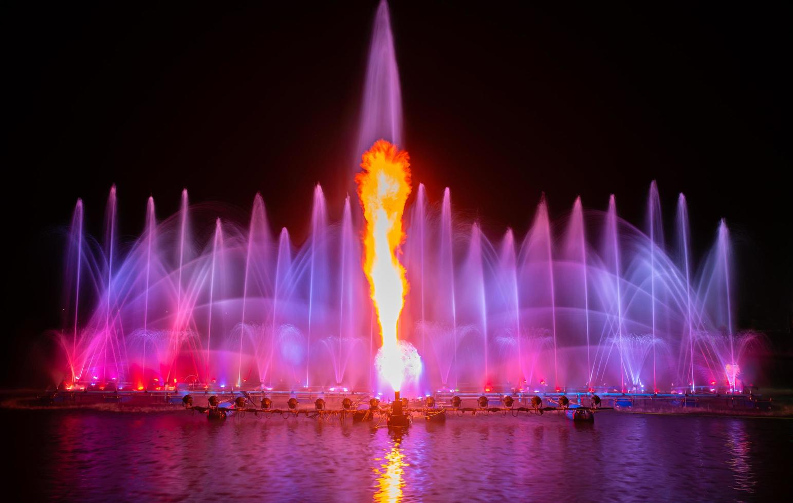 The colorful fountain dancing in celebration of year with dark night sky background. photo