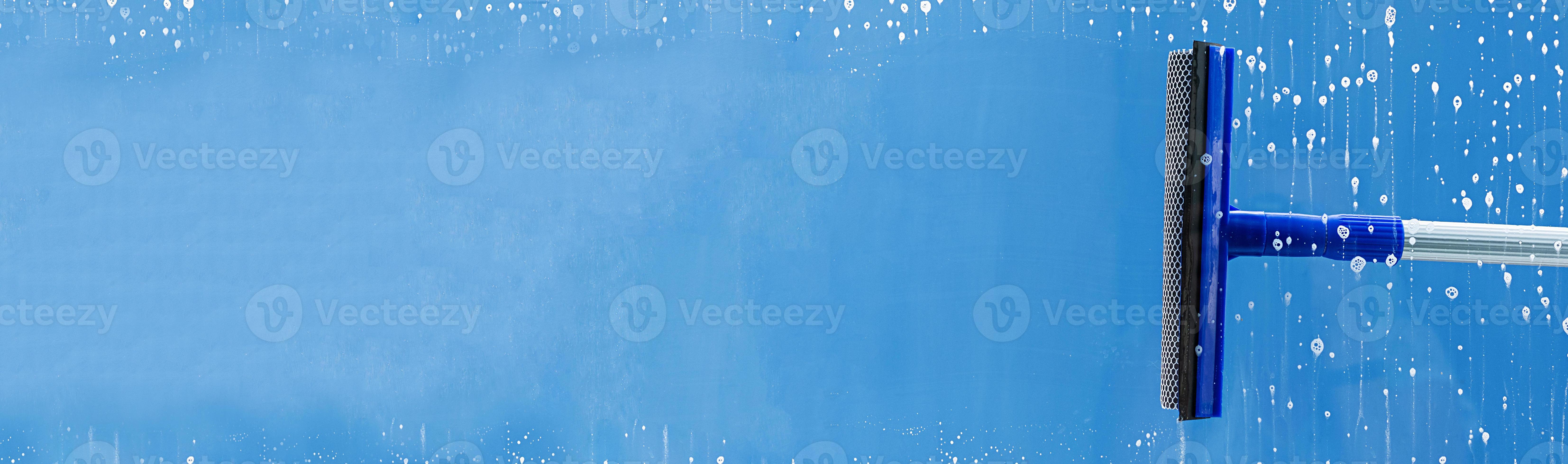 Rubber squeegee cleans window. Clears a stripe of soaped window. Cleaning service concept