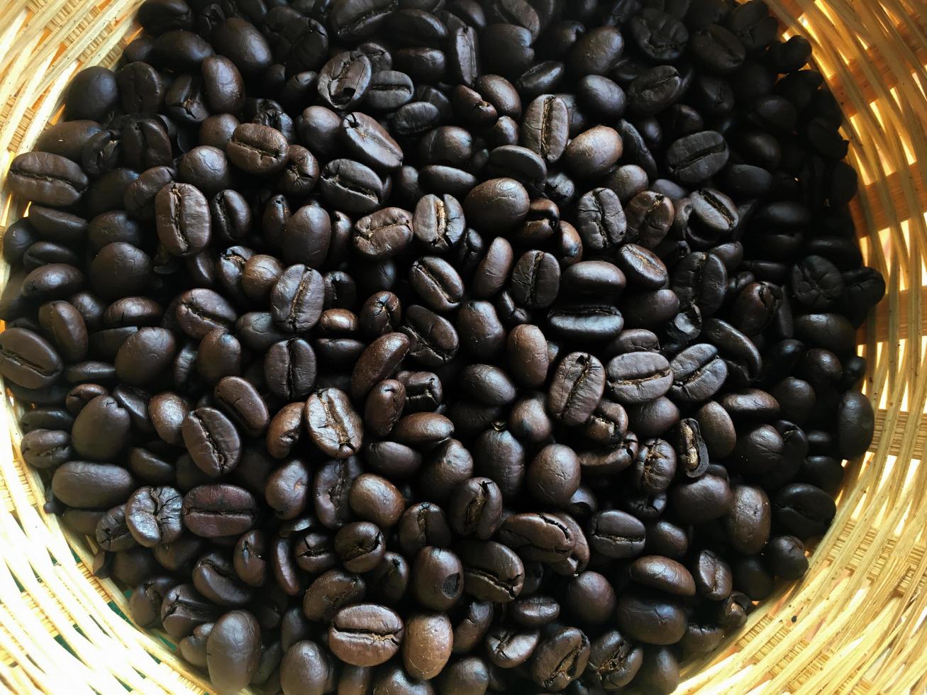 Organic asian coffee bean on wicker basket. photo