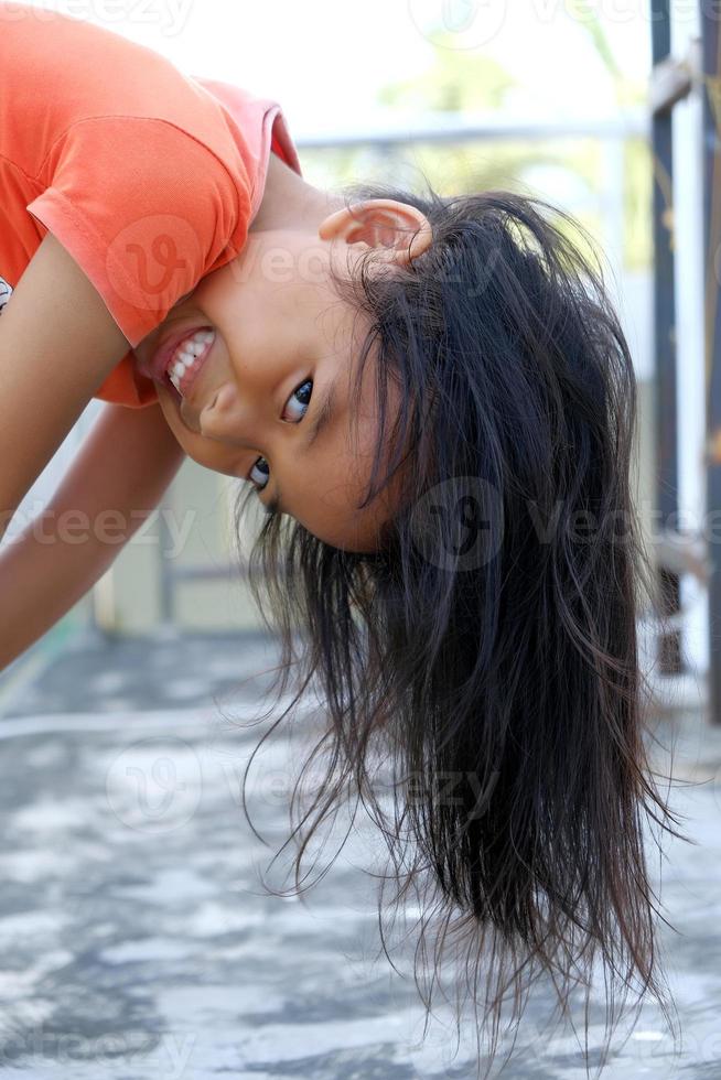 Happy expression Indonesian little girl with loose hair photo