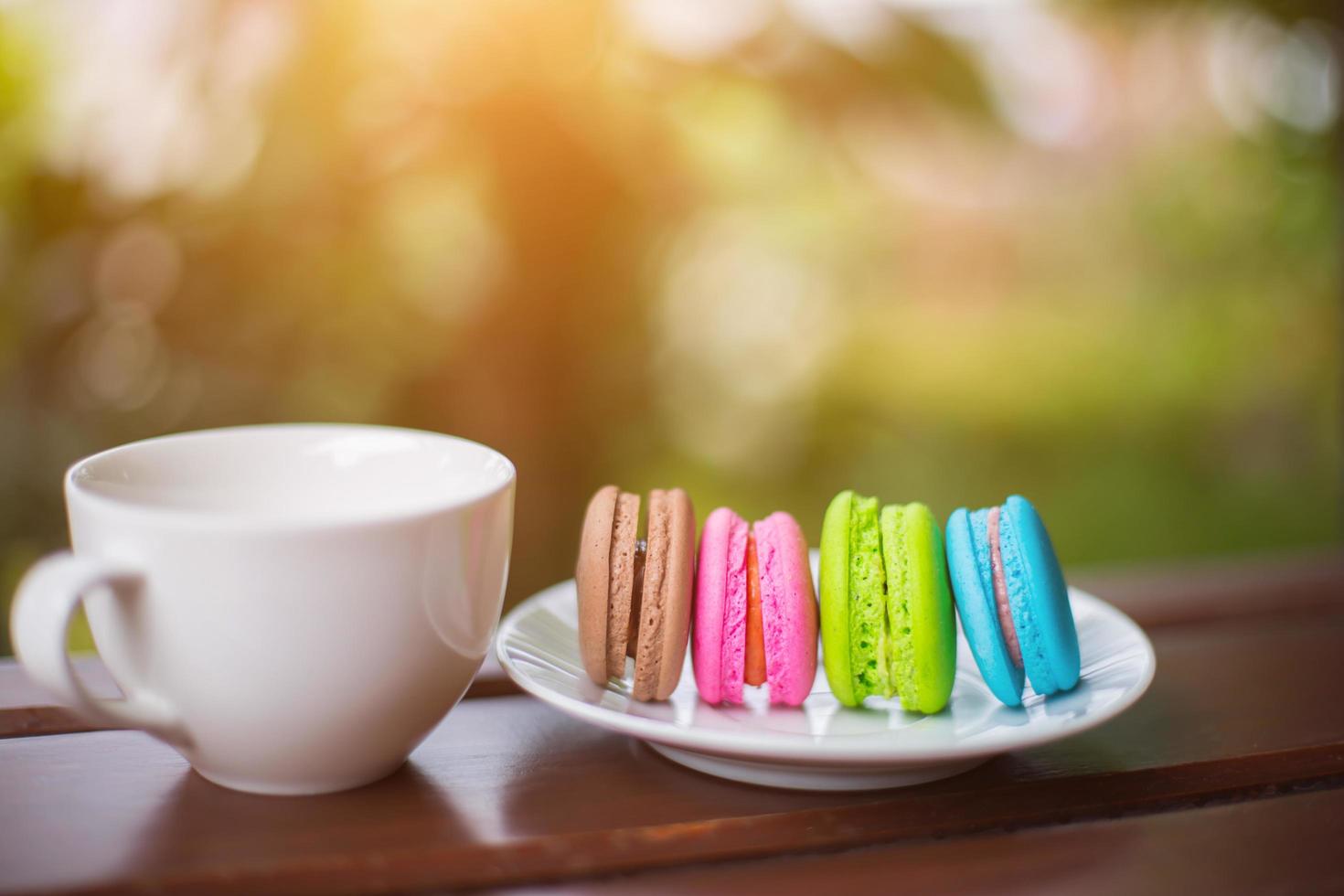valentine macaroons with coffee on wooden table. Toned image photo