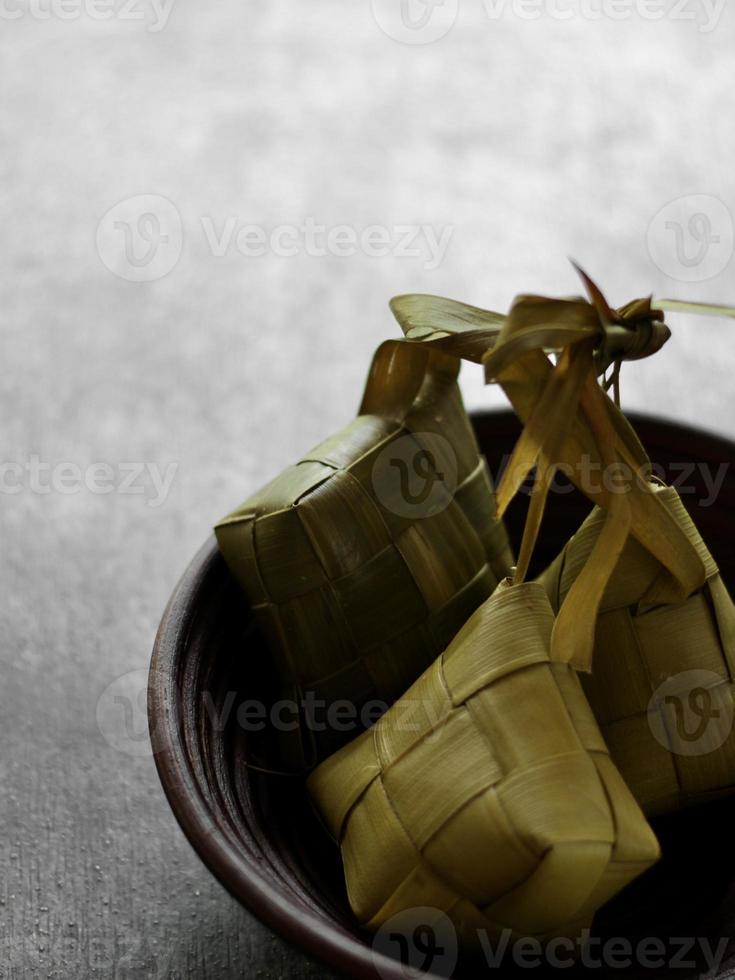 High angle view  of Ketupat in a bamboo bowl on the table photo