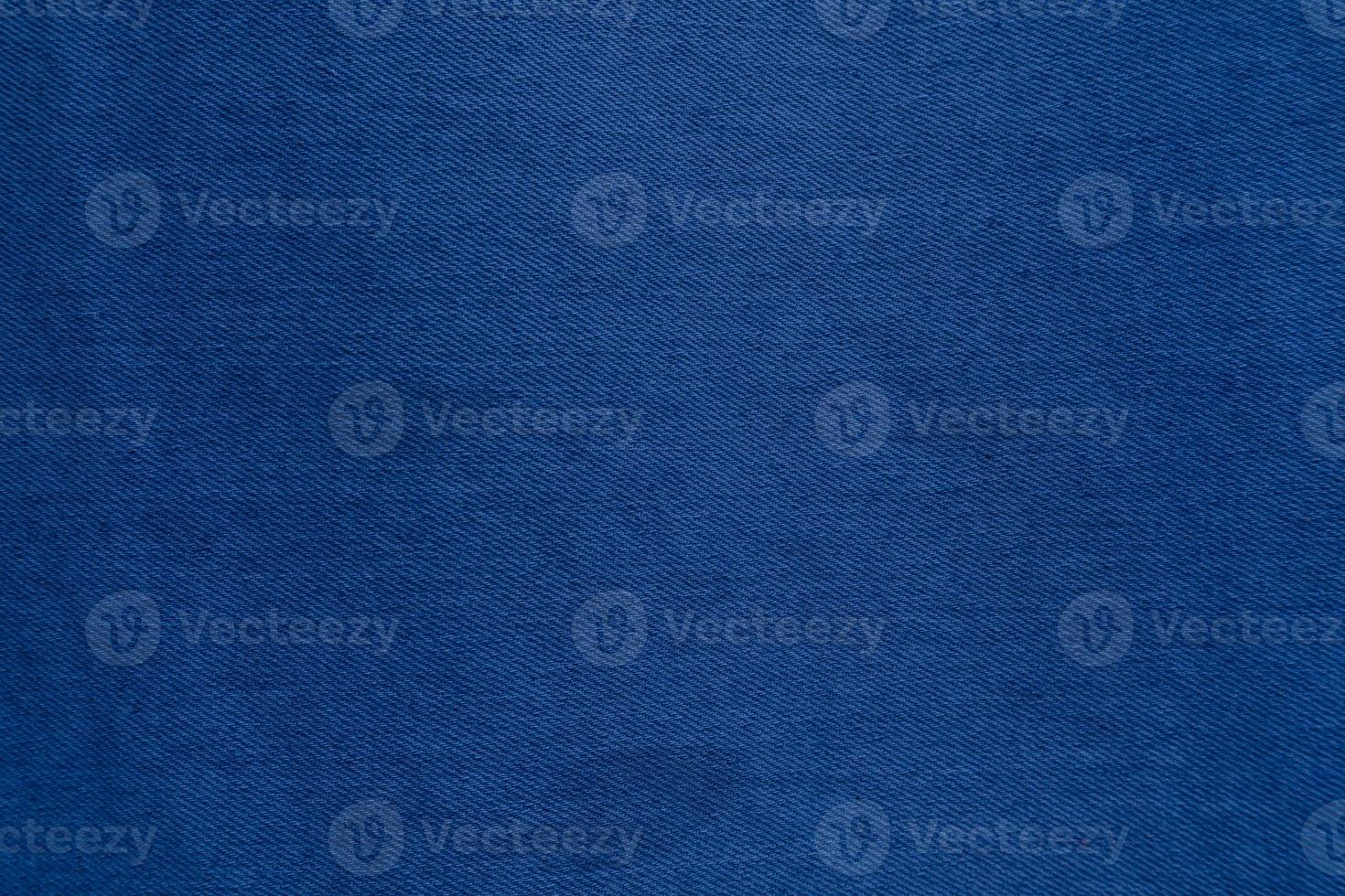 Dark Blue denim fabric texture background, the strong cotton cloth used especially to make jeans. photo
