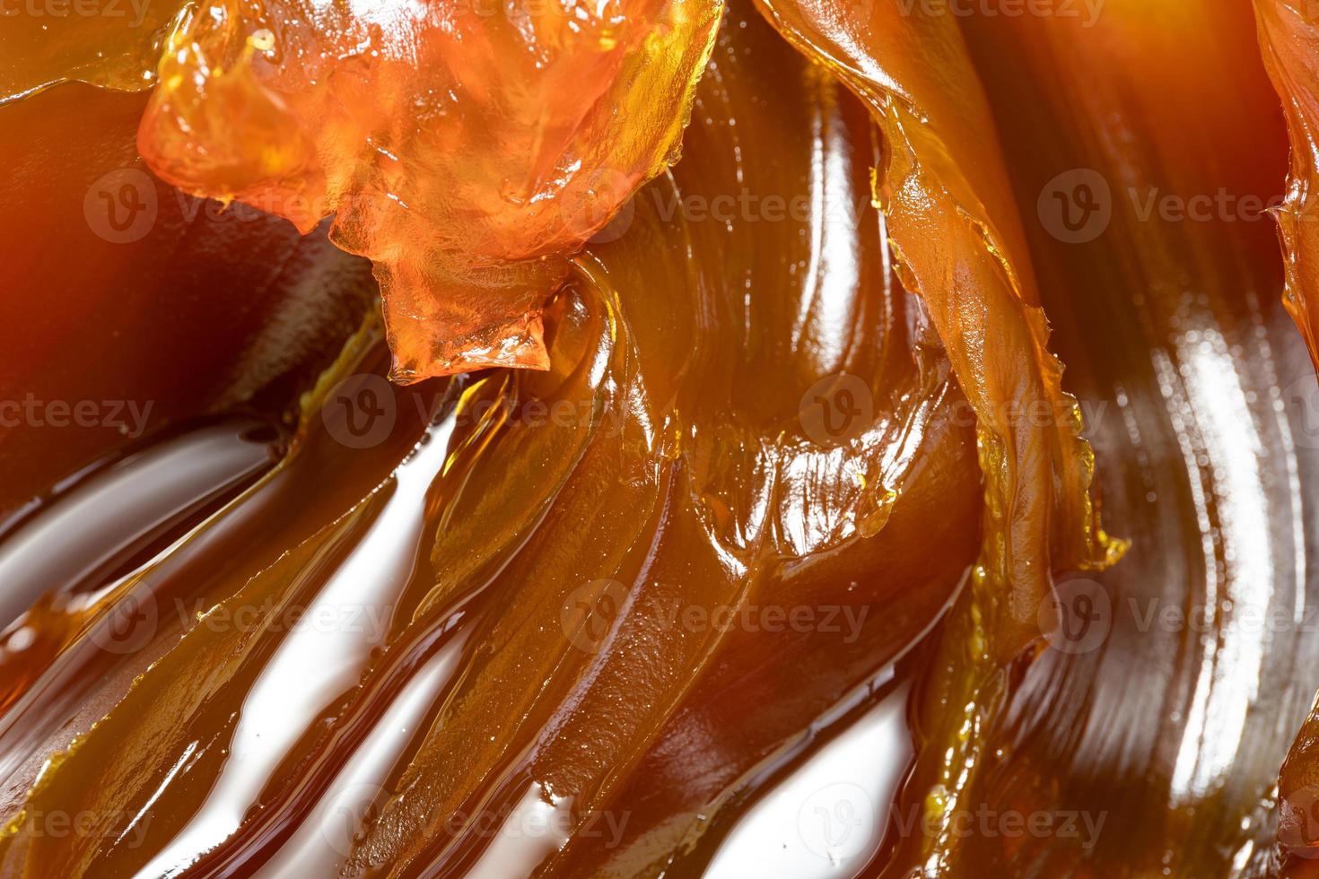 Close up of orange colored industrial grease. Rich and thick texture of industrial grade grease used to smooth out all metal friction. Lubricating grease. close-up of yellow lithium grease for machine photo