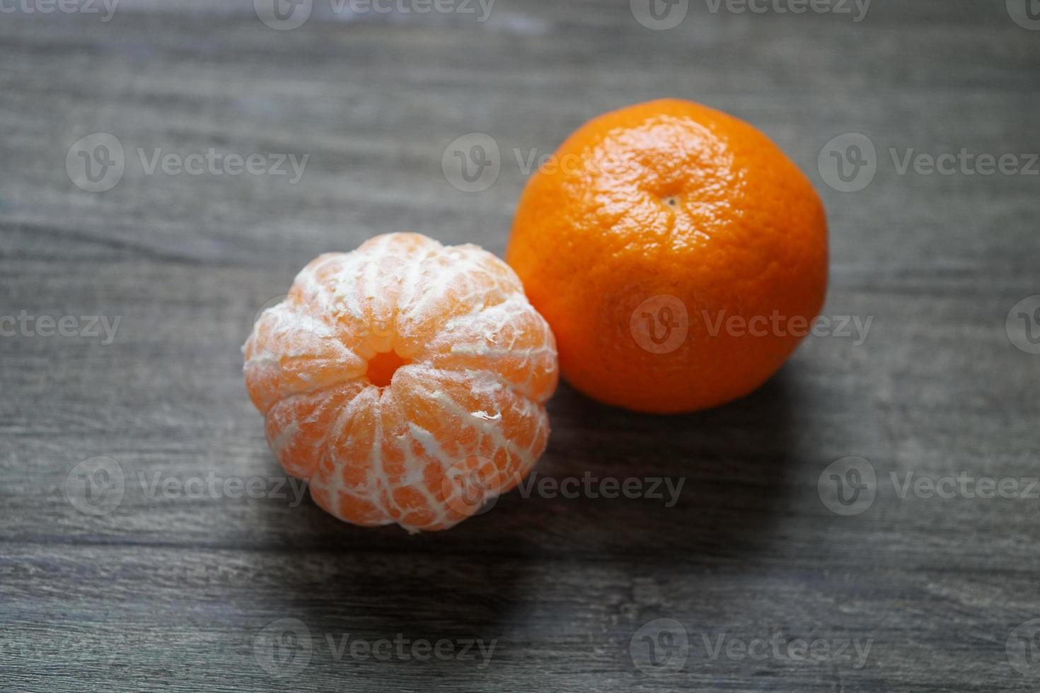 clementines or tangerines or mandarin oranges on rustic wooden table photo