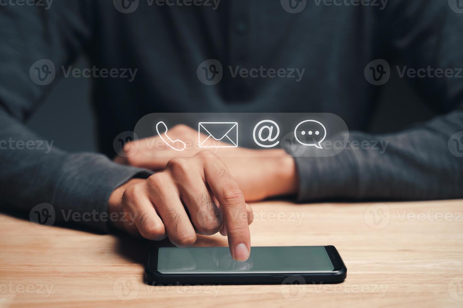 Customer support hotline Contact us people connection. Businessman using smartphone with the email, call phone, address, Chat message icons. photo