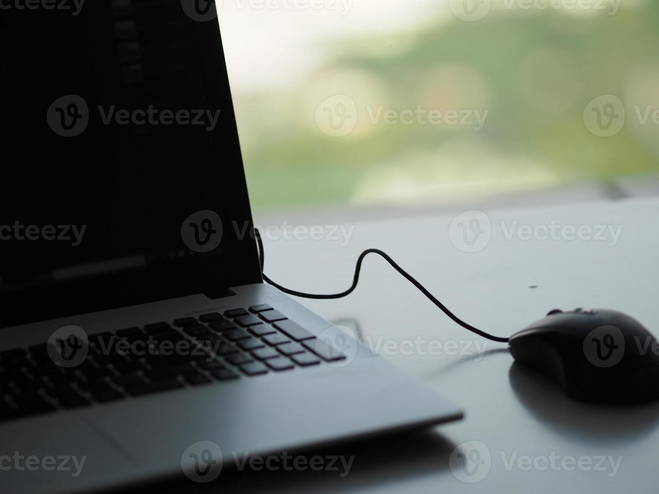 notebook with mouse on the table photo