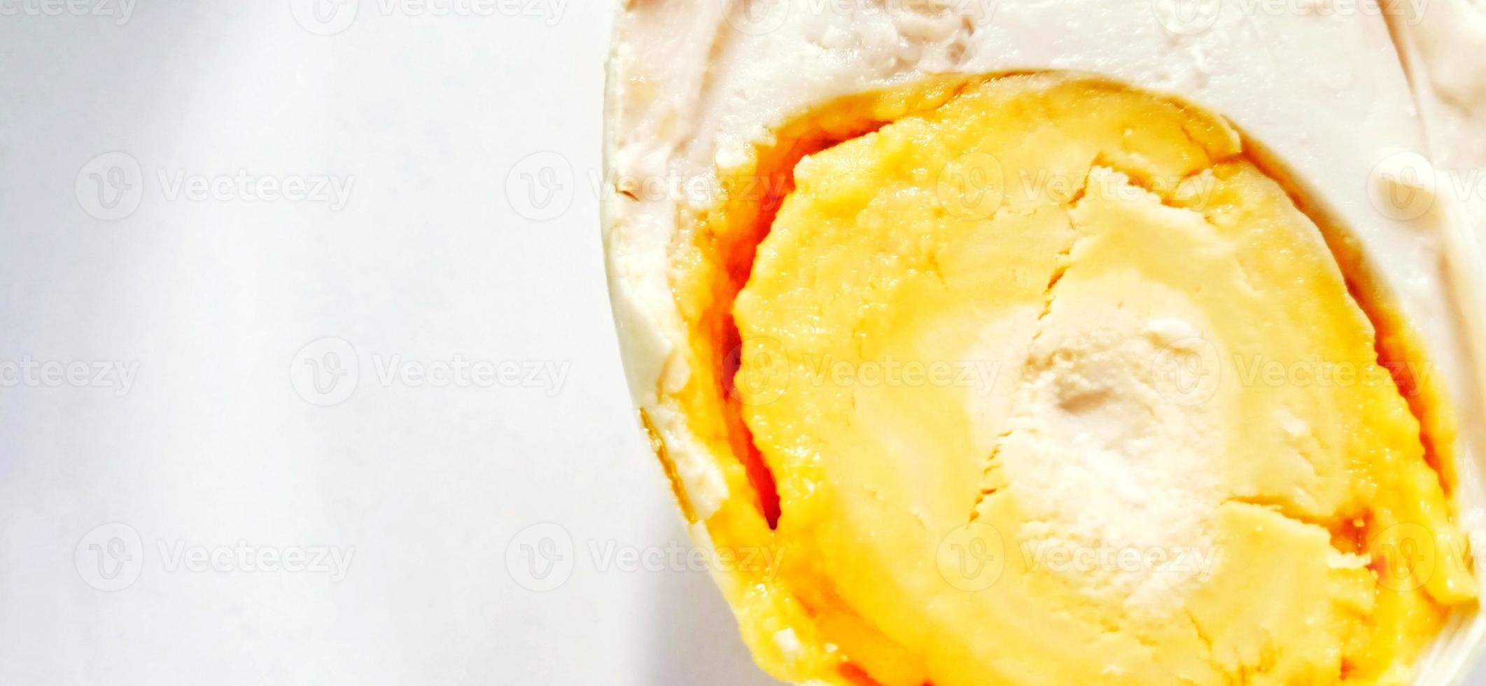 Indonesian food slice of salted egg or telur asin on the white gray plate background. Food ingredient background design. Suitable for advertising of food, drink, poster, backdrop, food company, etc. photo