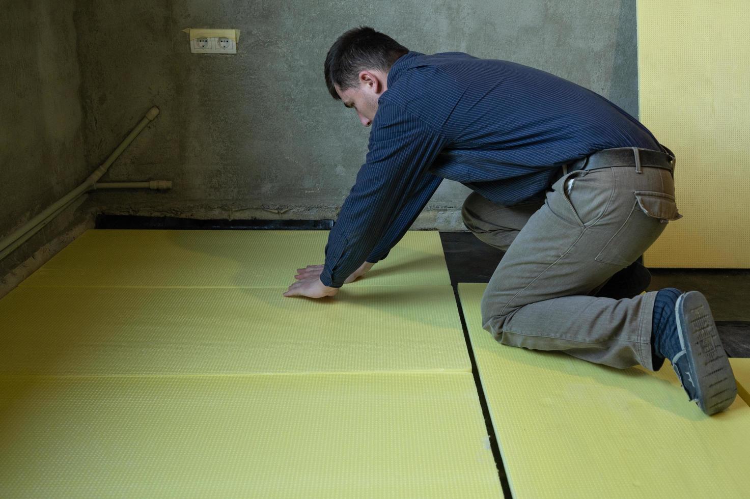 Installation of expanded polystyrene for floor insulation. photo