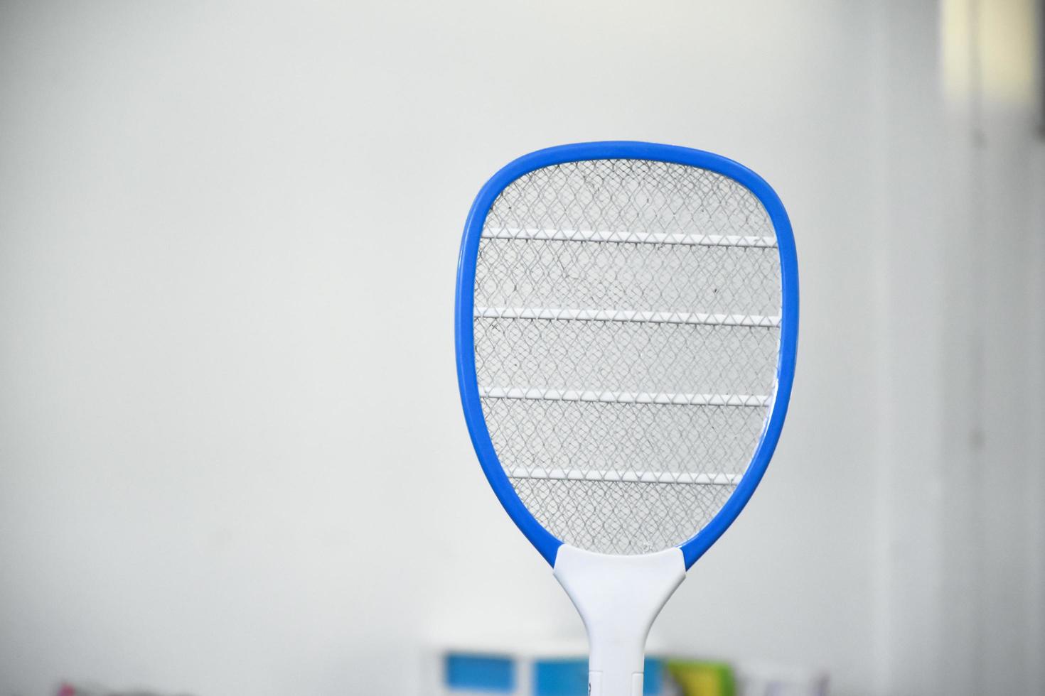 Electronic mosquito swatter in the office room for killing mosquitoes and insects inside the office, soft and selective focus. photo