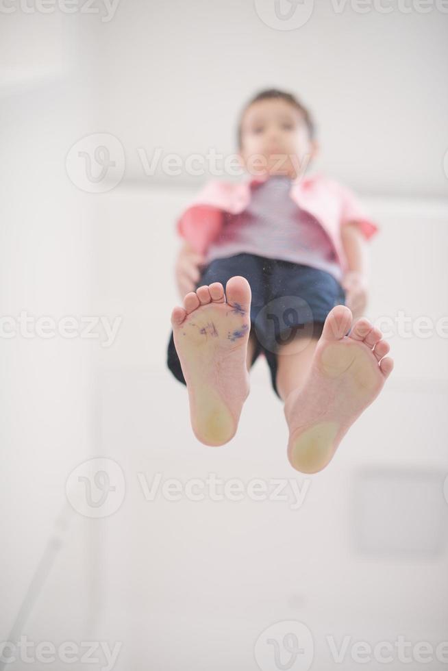 little boy standing on transparent glass floor photo