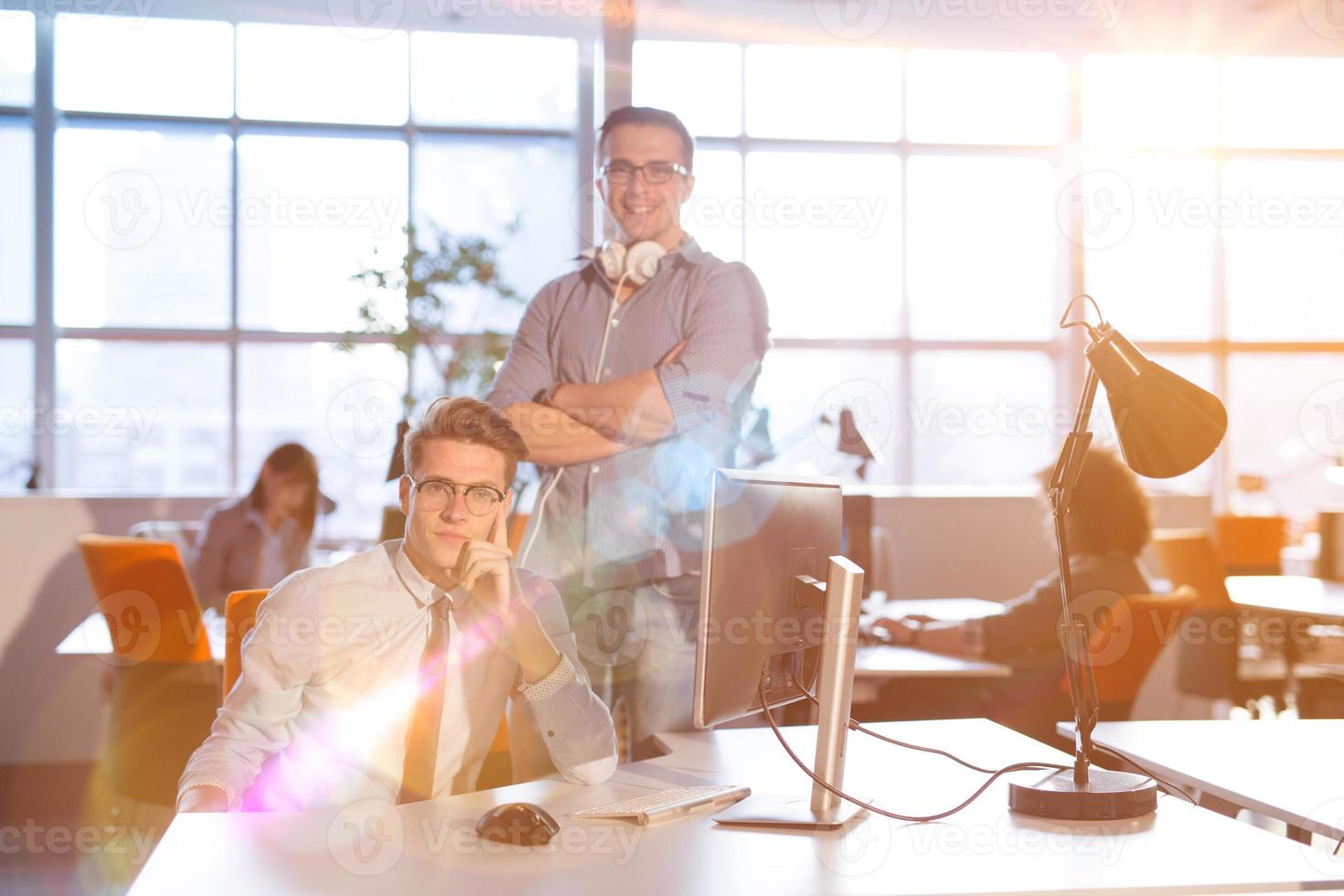 Young businessman helping his colleague at the work photo
