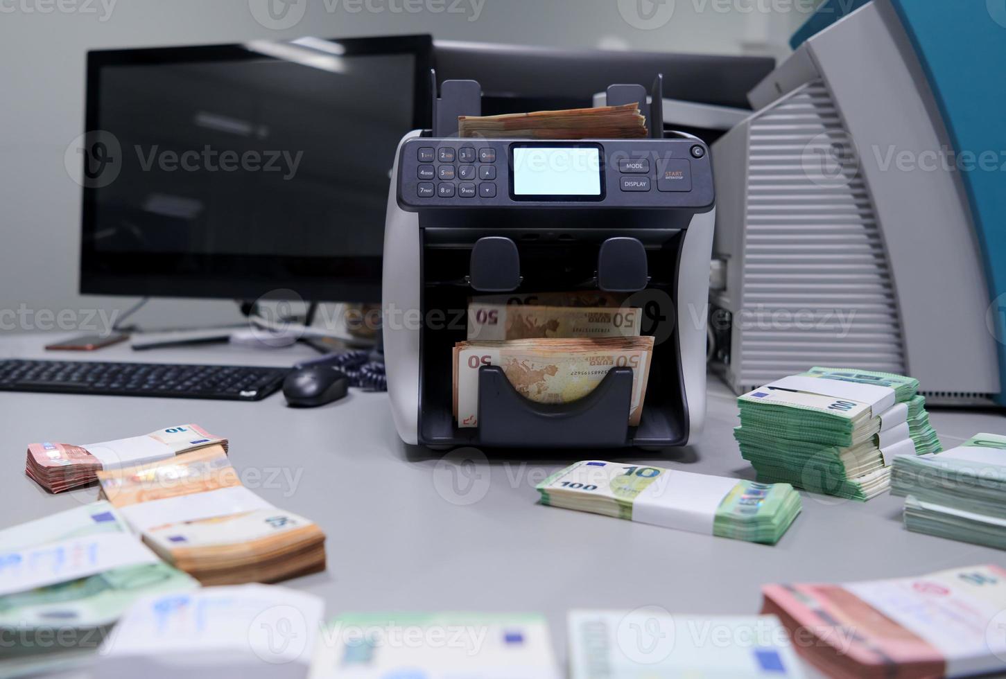 banknotes in front of electronic money counting machine photo