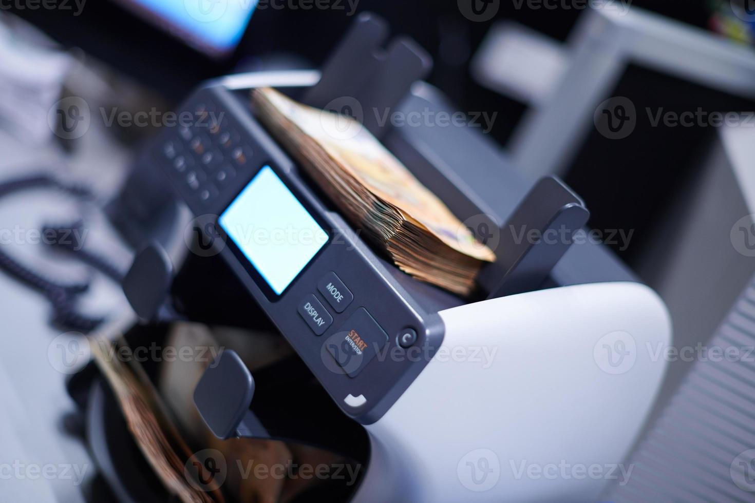 banknotes in front of electronic money counting machine photo