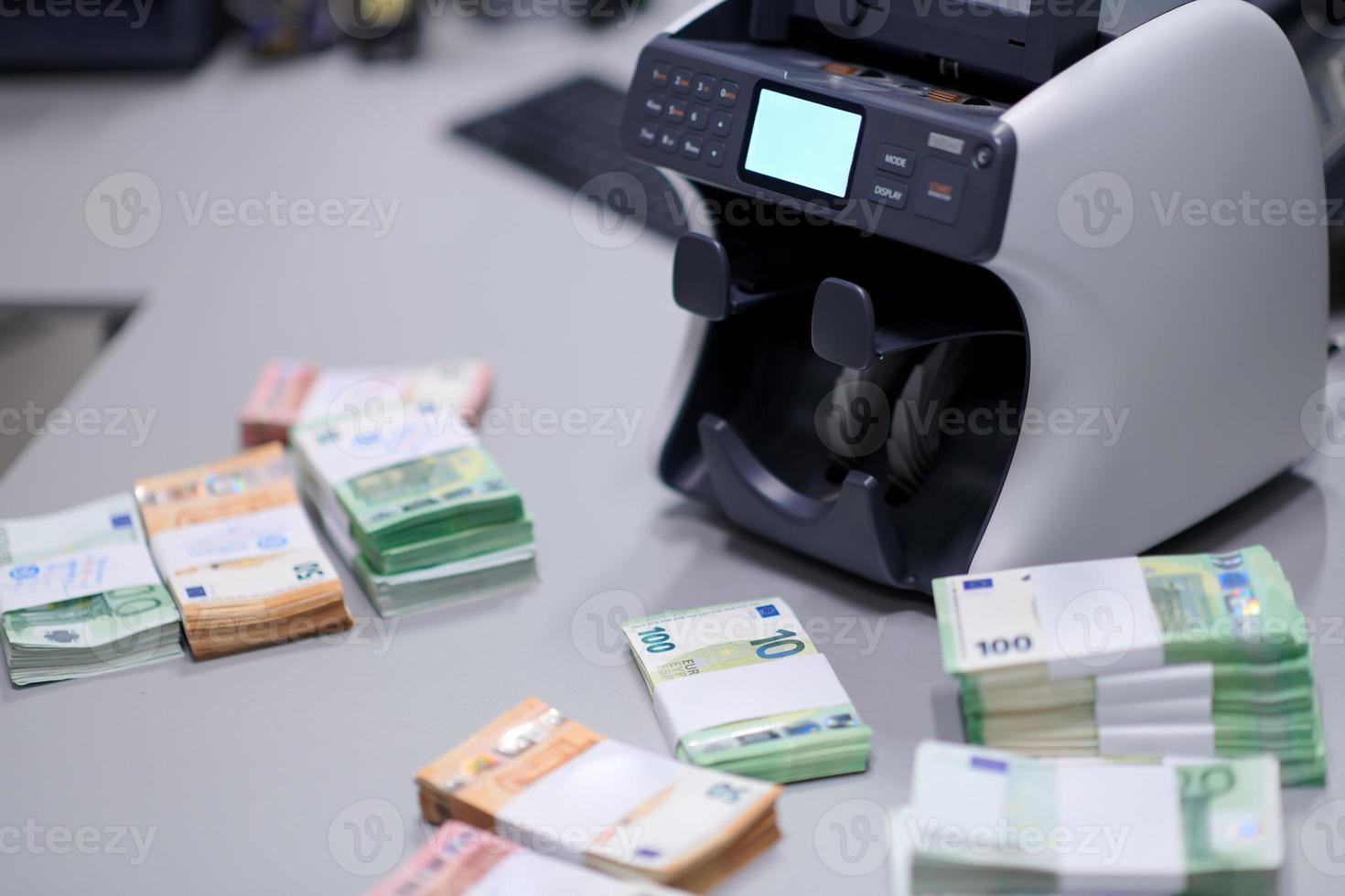 banknotes in front of electronic money counting machine photo