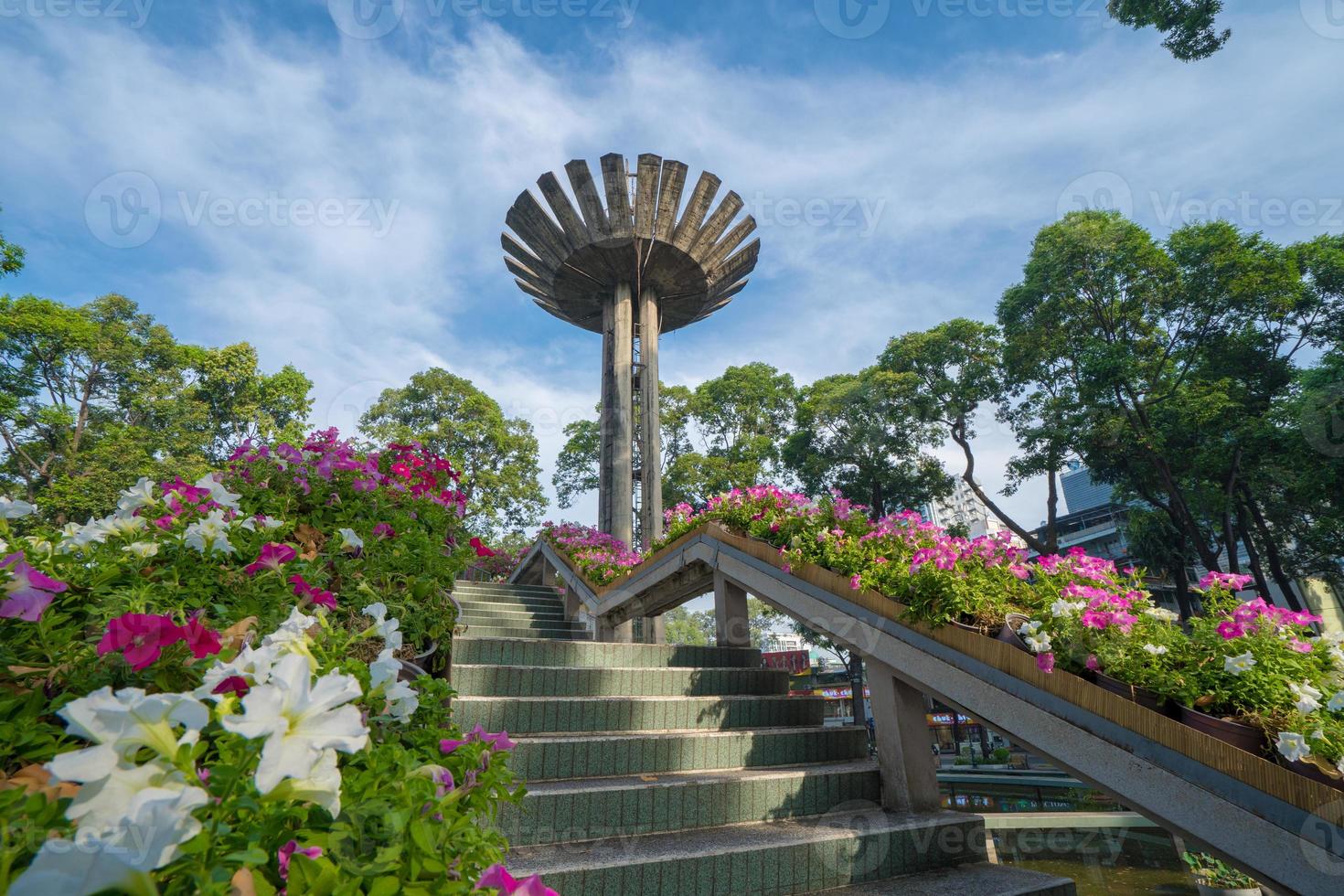 Wide angle view of Lotus pillar - An iconic architecture at Turtle lake , Ho Con Rua with blue sky in Saigon. photo