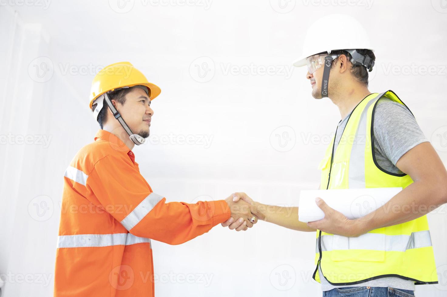 Architects meeting to plan new projects Measure the house plan at the construction site photo