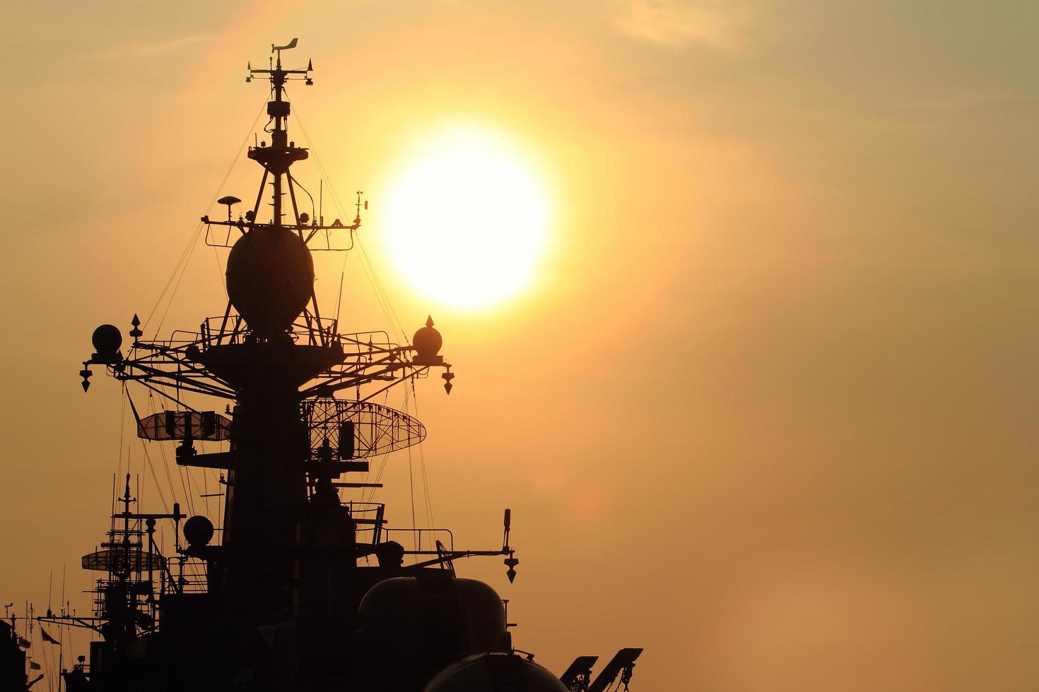 battleship with sunset behind photo