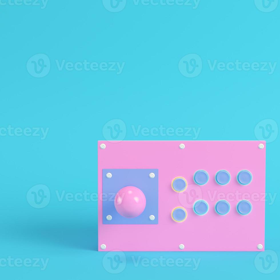 Retro arcade game controller on bright blue background in pastel colors photo