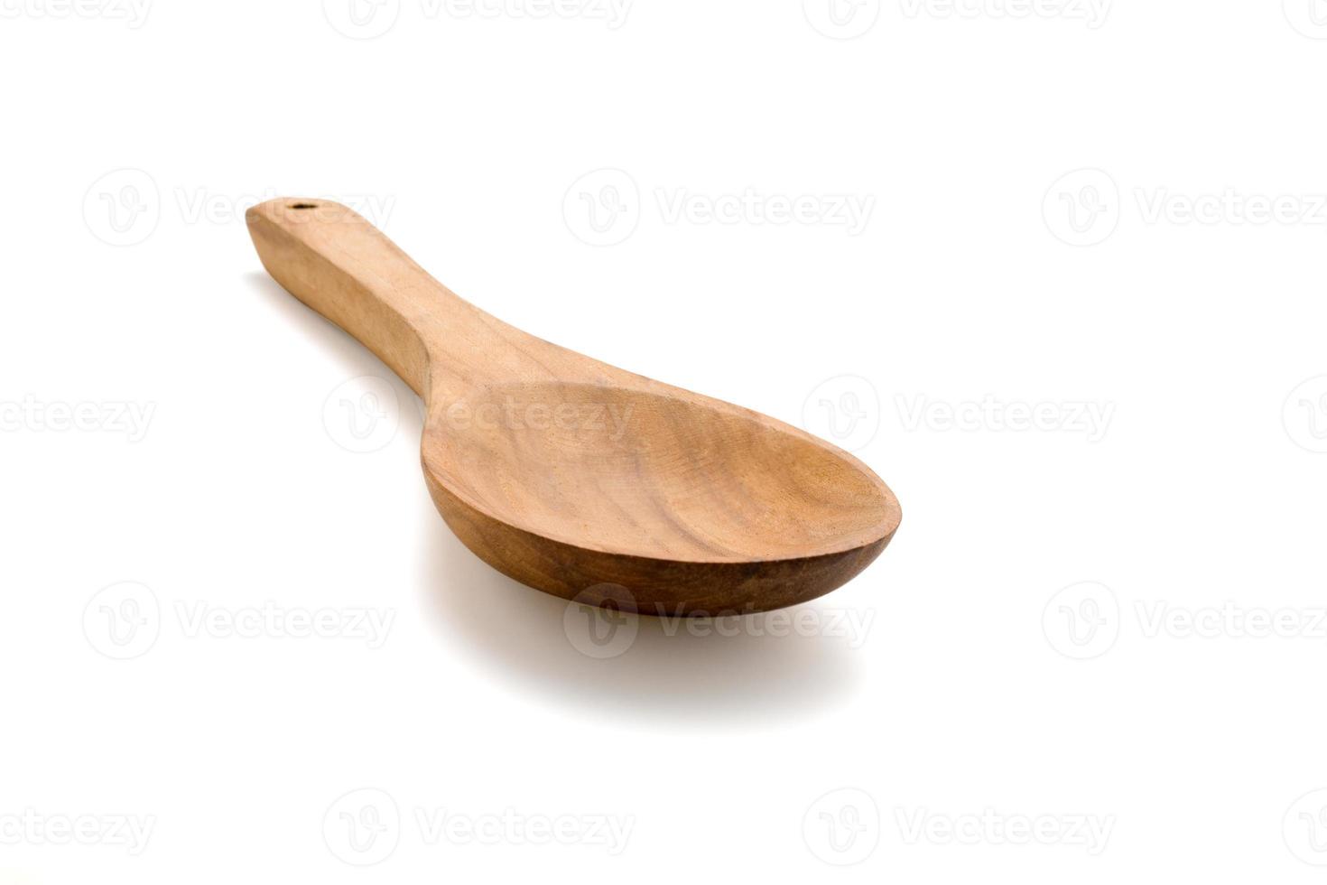 Empty wooden spoon isolated on white photo