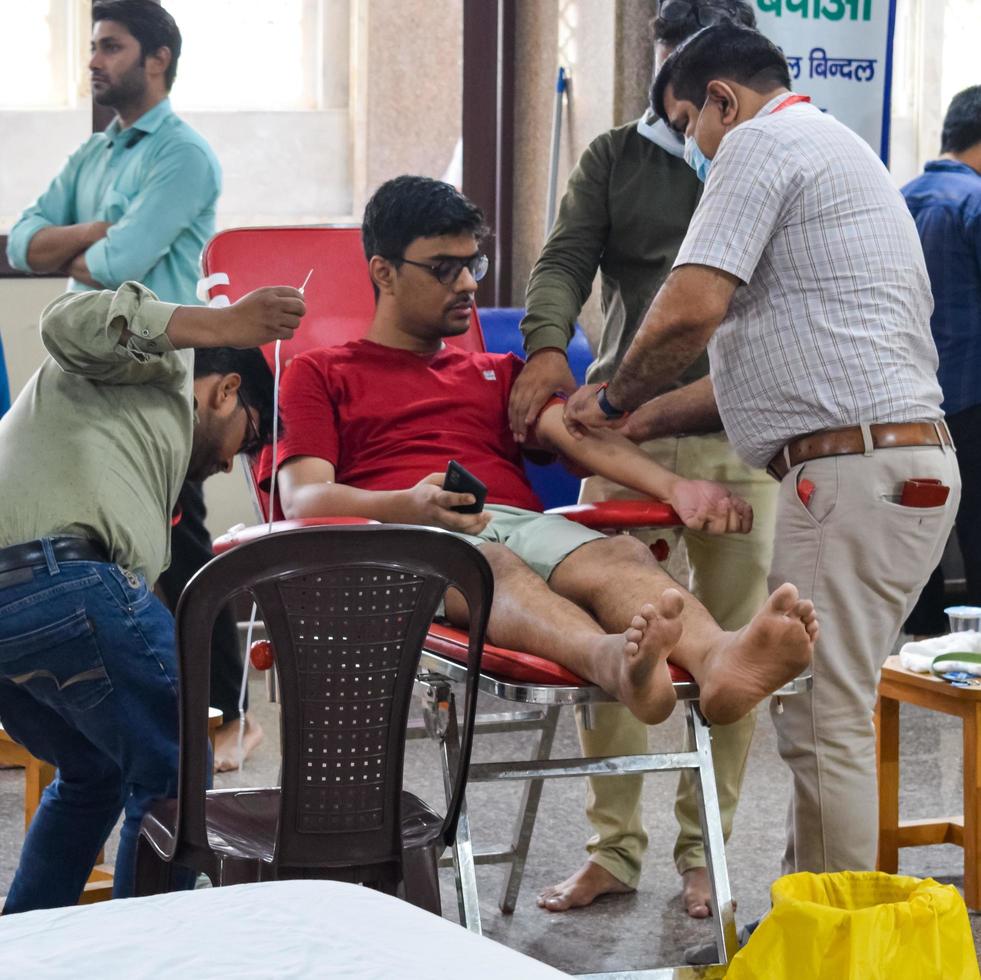 Delhi, India, June 19 2022 - Blood donor at Blood donation camp held at Balaji Temple, Vivek Vihar, Delhi, India, Image for World blood donor day on June 14 every year, Blood Donation Camp at Temple photo