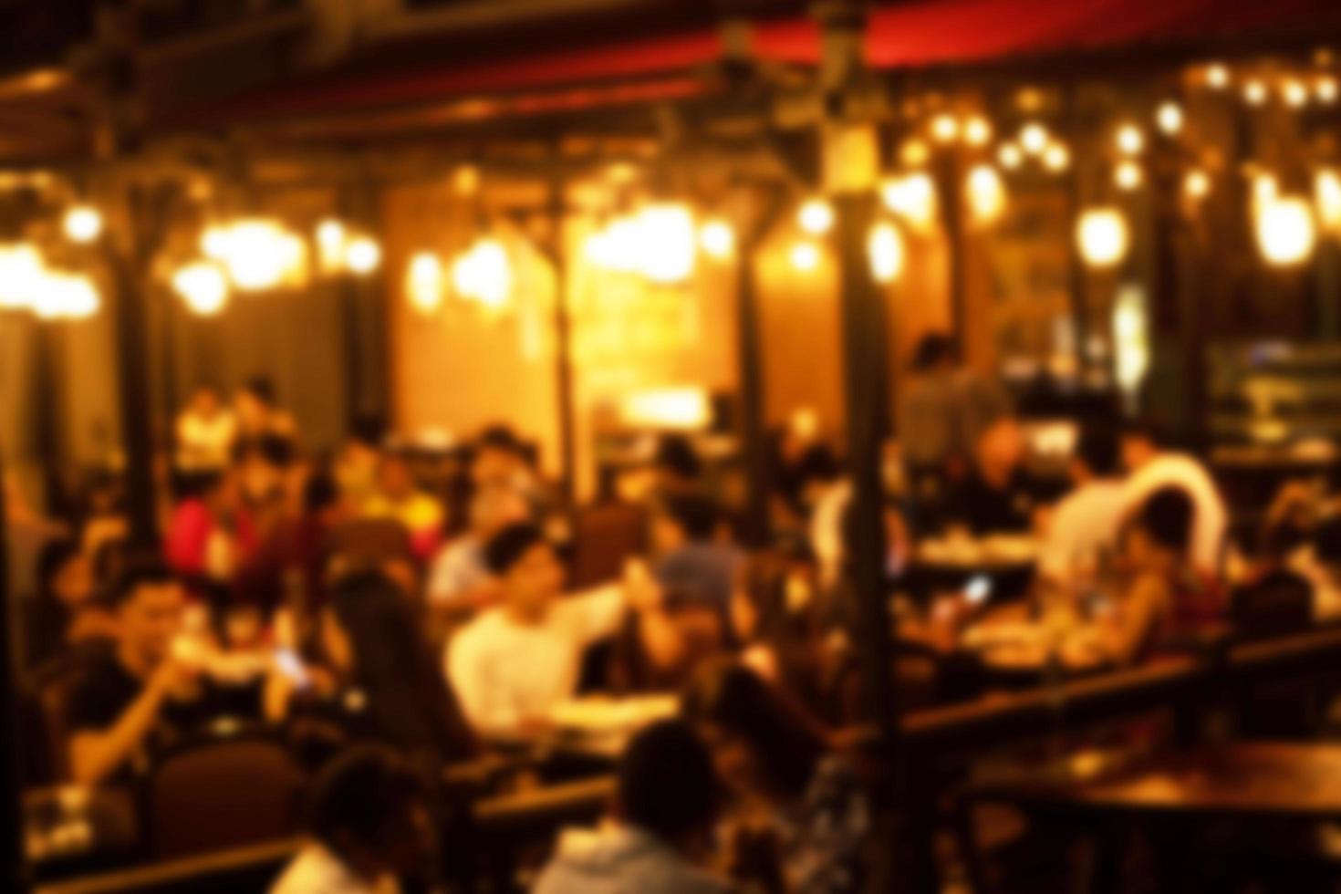 blurred image at the restaurant night time, many people in the restaurant eat and party happy relaxing photo
