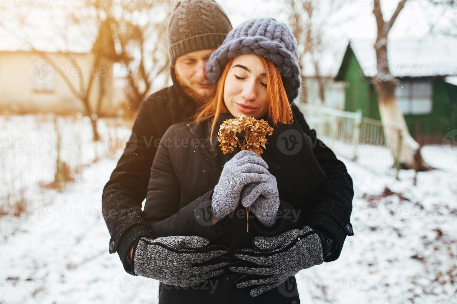 man hugging his girlfriend on the street photo