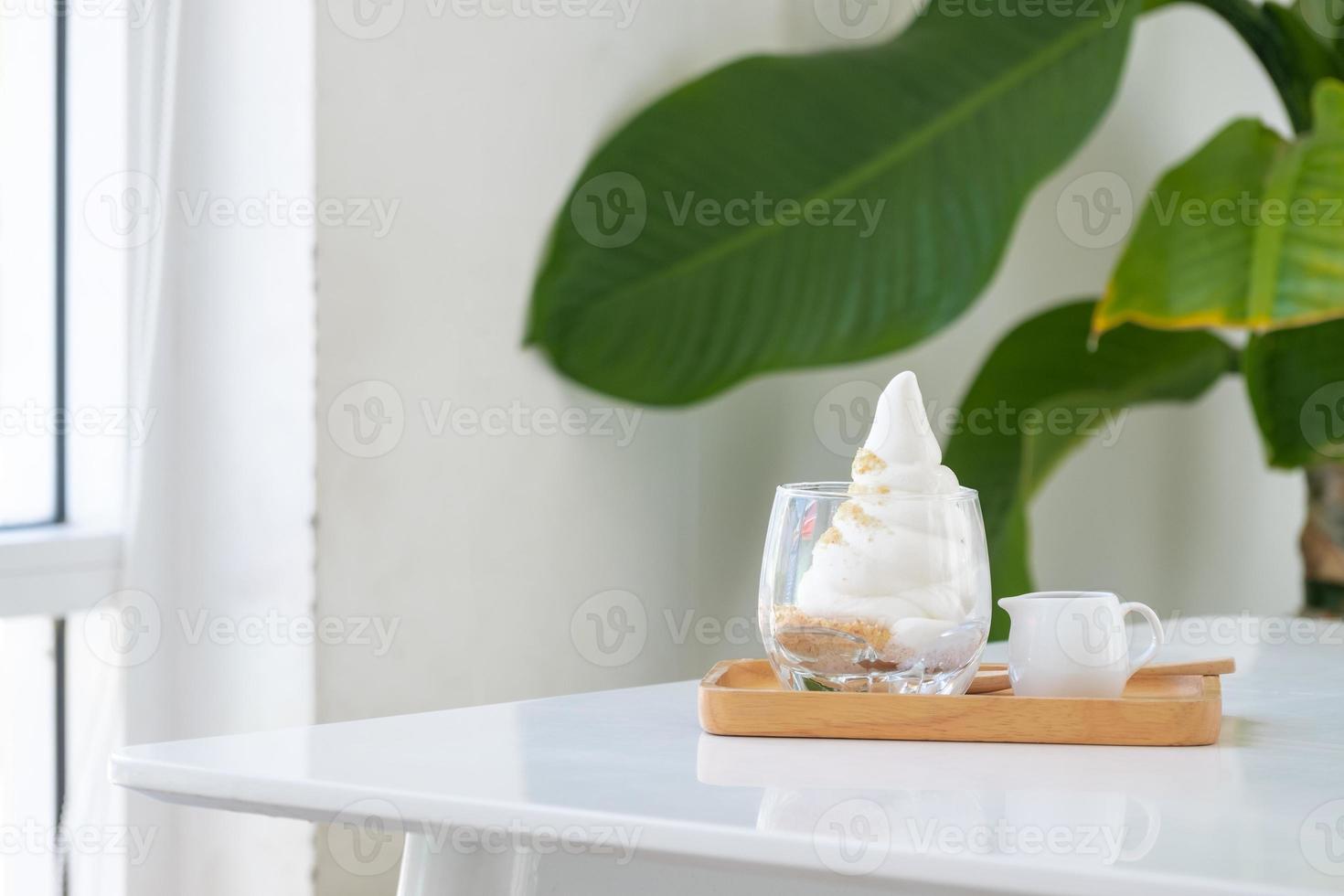 Affogato Espresso on wooden disk on the white table near windows in coffee shop, ice cream, cafe, copy space photo