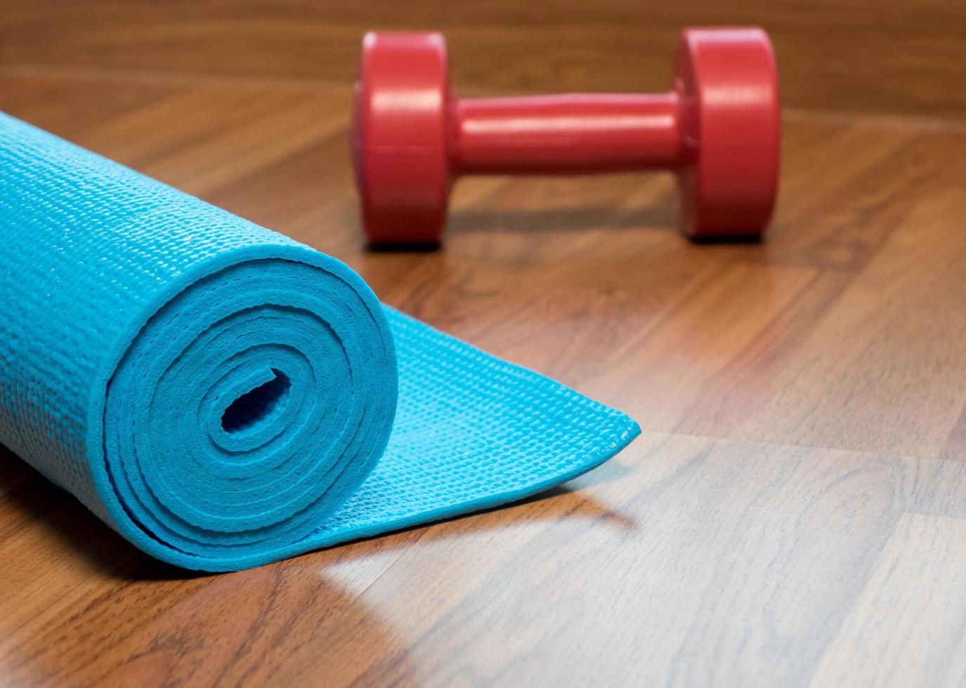 Blue yoga mat and Red dumbbell photo