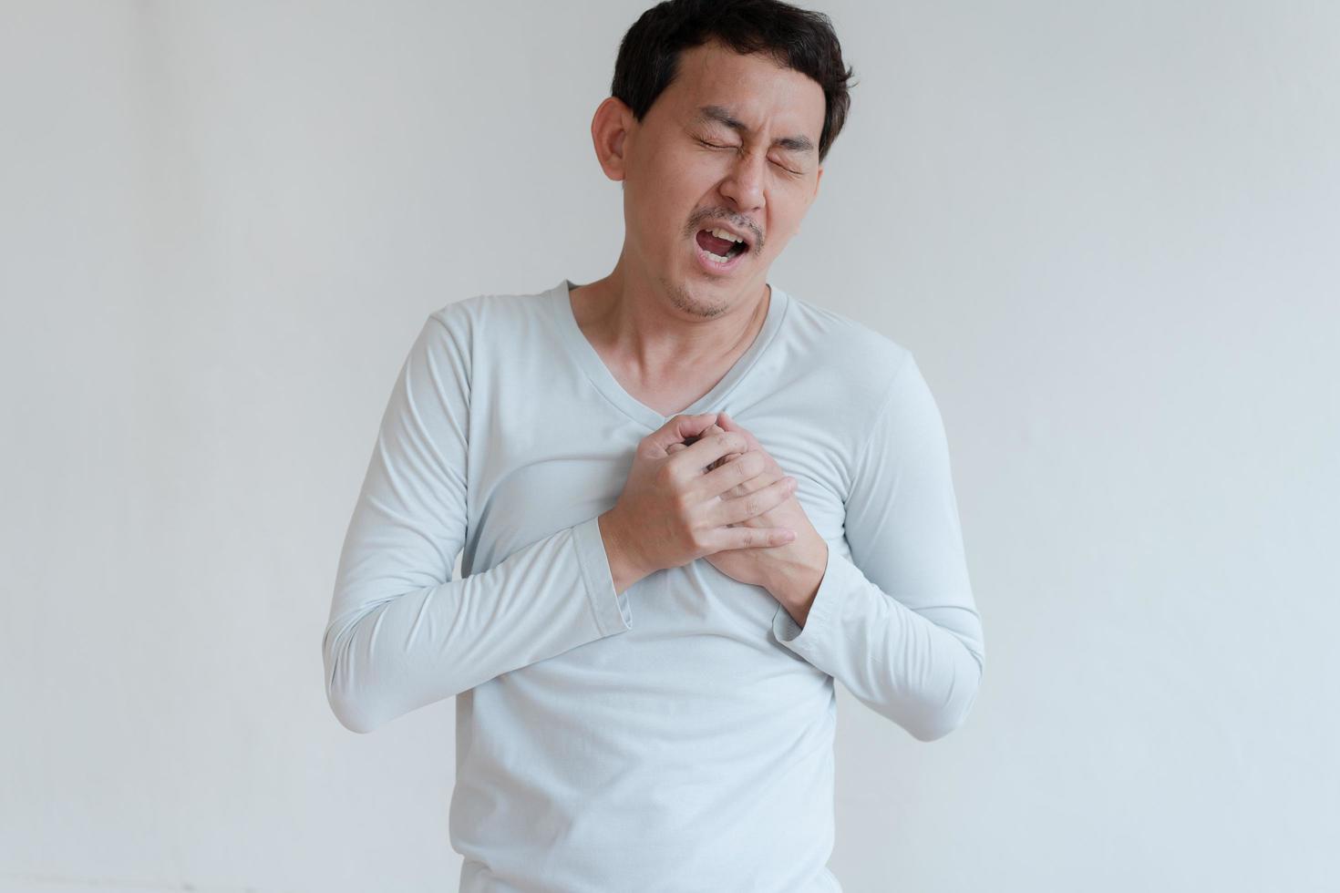 a man touching his heart, with red highlight of heart attack, and others heart disease concept, Heart attack symptom photo