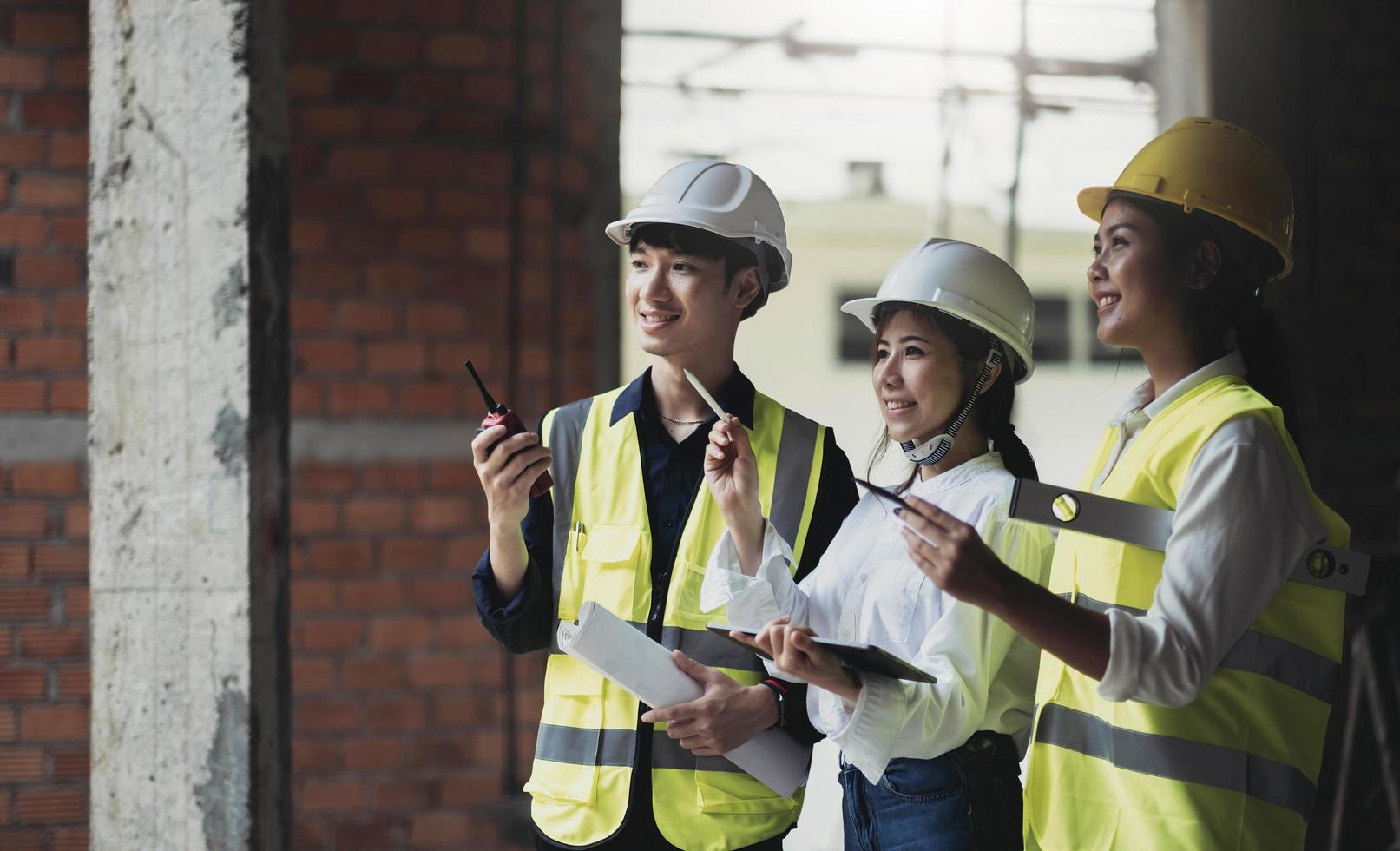 Professional Construction and Engineer team Working on workplace. Professional black architect and construction worker working look at blueprint plan on site. photo