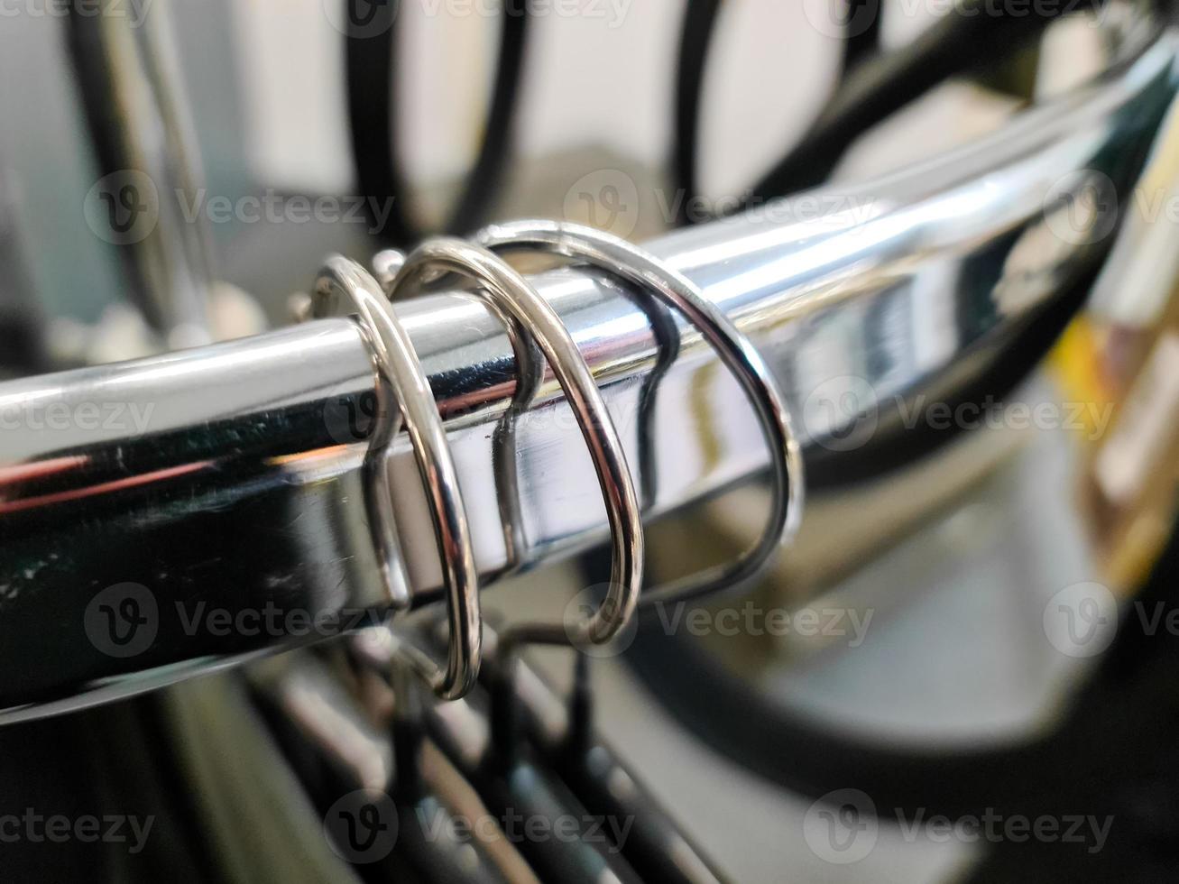 Close up view of several hangers with jackets on them hanging on a clothes rail. photo