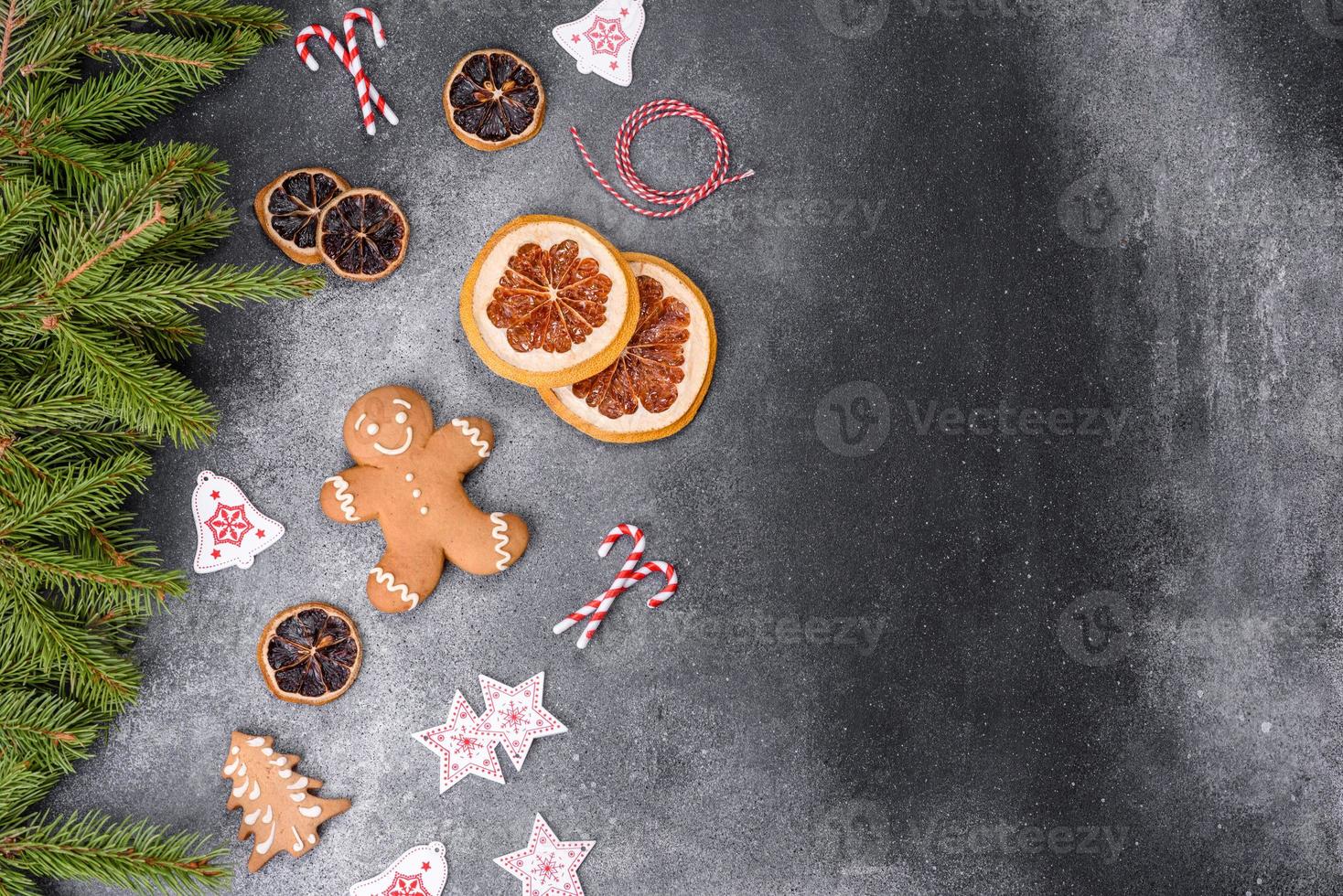 Gingerbread, Christmas tree decorations, dried citrus fruits on a gray concrete background photo