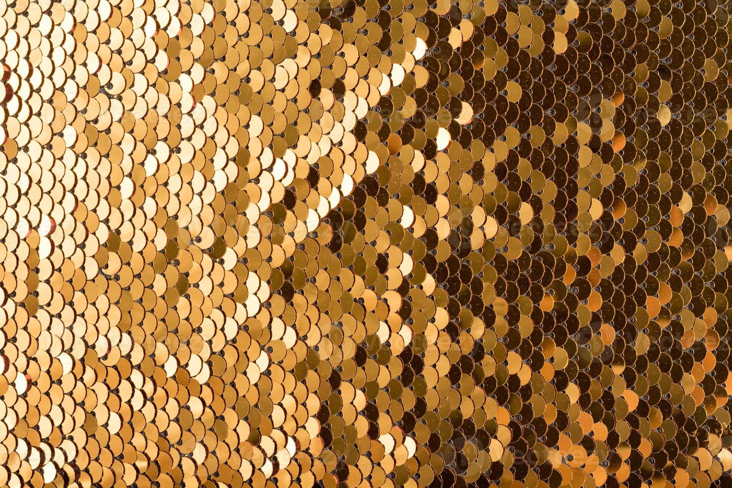 Sequins background. Multicolored sequins. Background with shiny sequins on fabric. photo