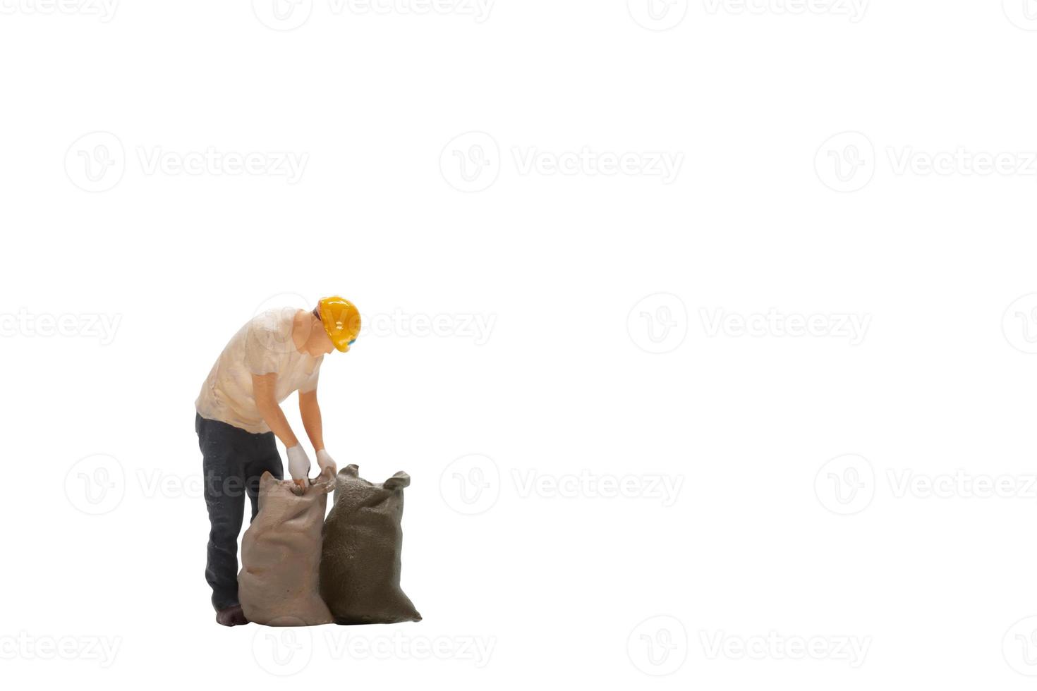 Miniature worker isolated on white background with clipping path photo