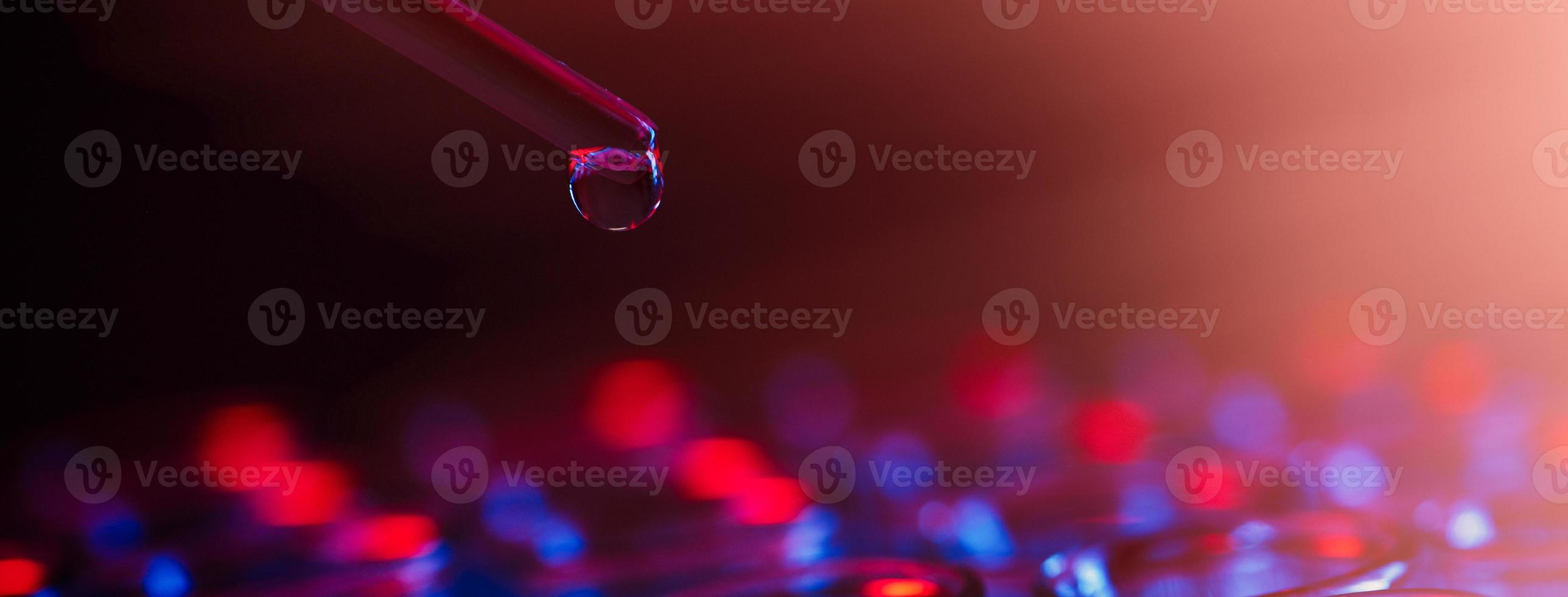 Test tube row. Concept of medical or science laboratory, liquid drop droplet with dropper in blue red tone background, close up, micro photography picture. photo