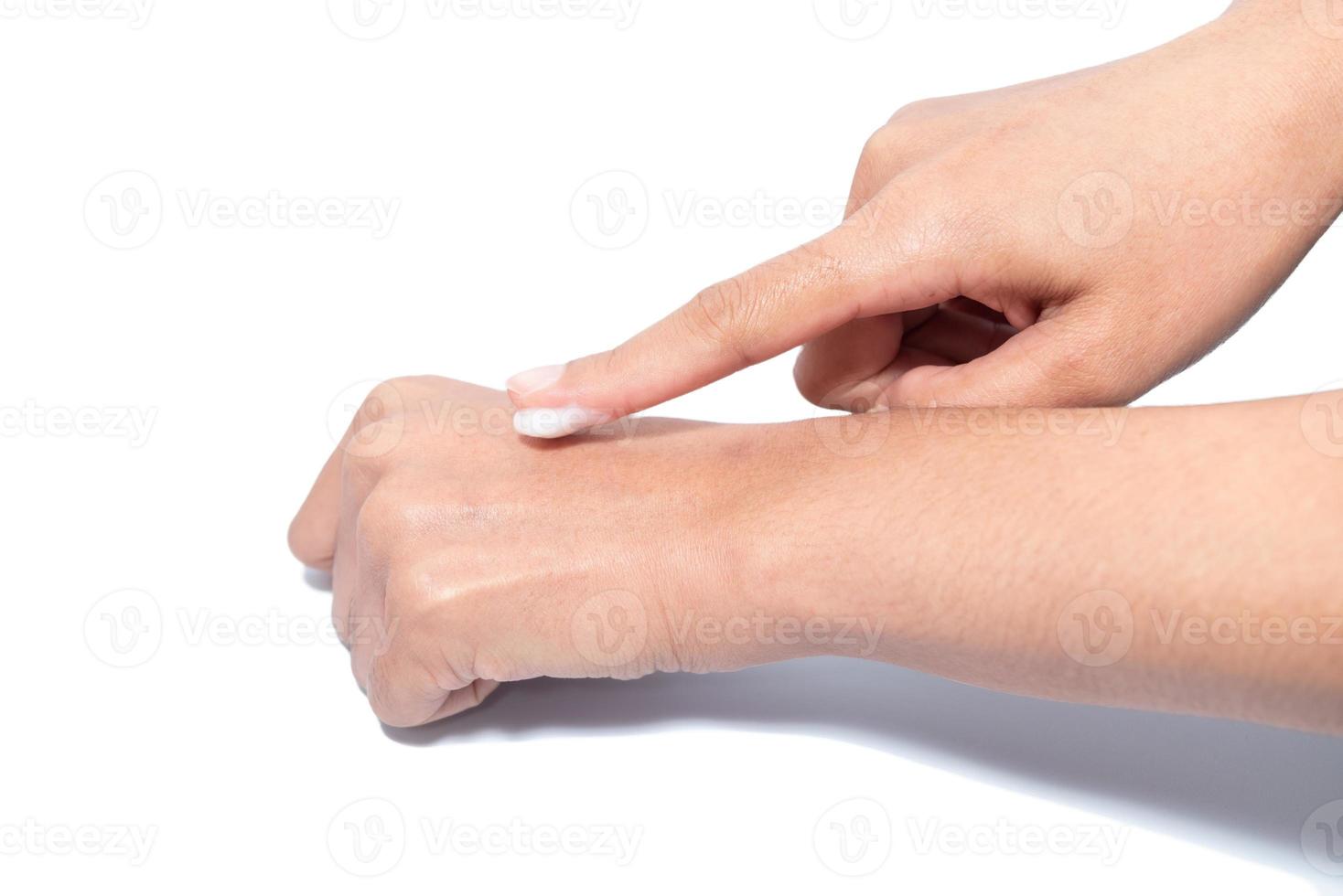 Closeup woman applying protective cream on hands. photo